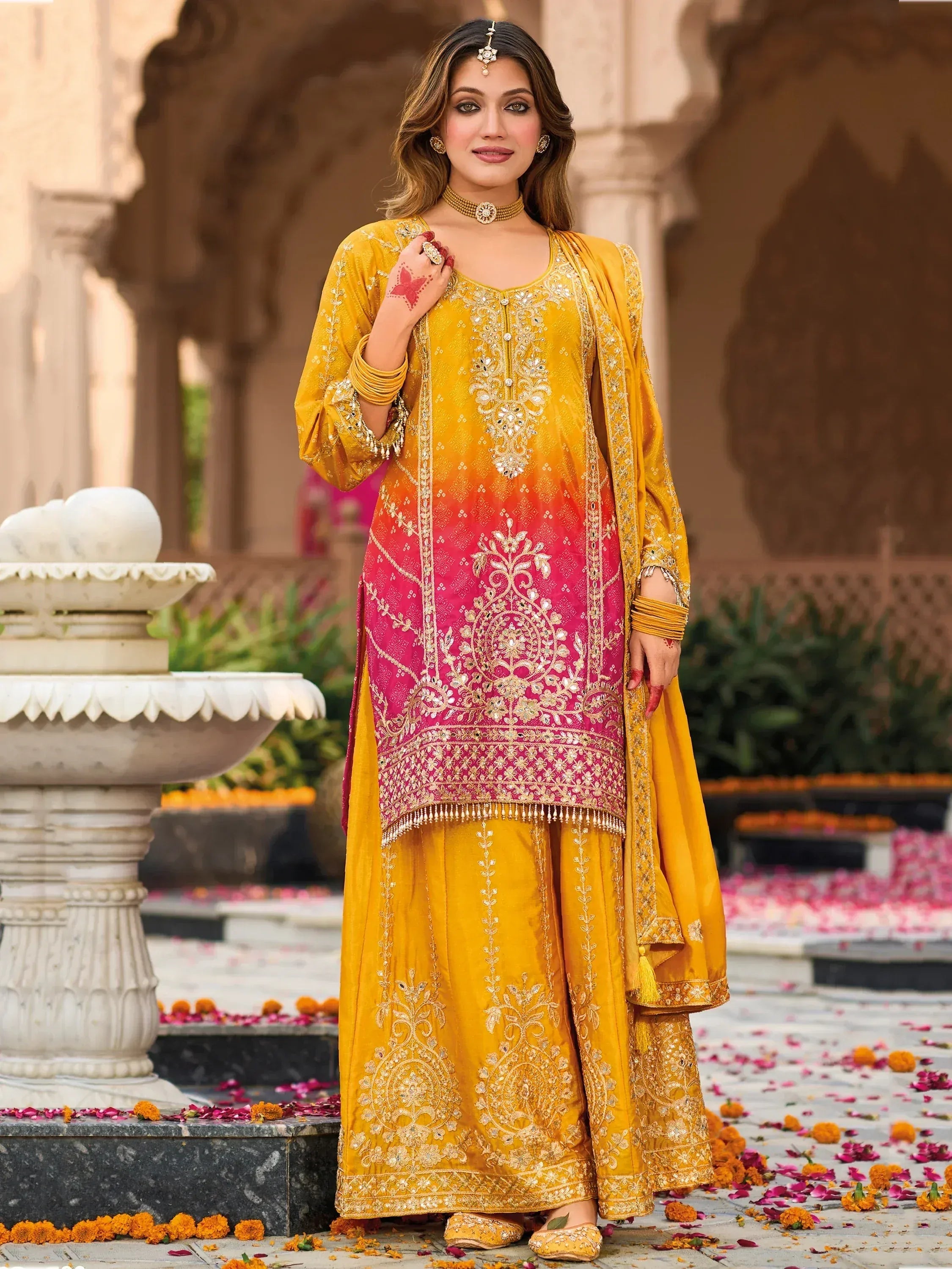 Yellow and pink embroidered salwar kameez with floral motifs, perfect for Indian ethnic wear occasions