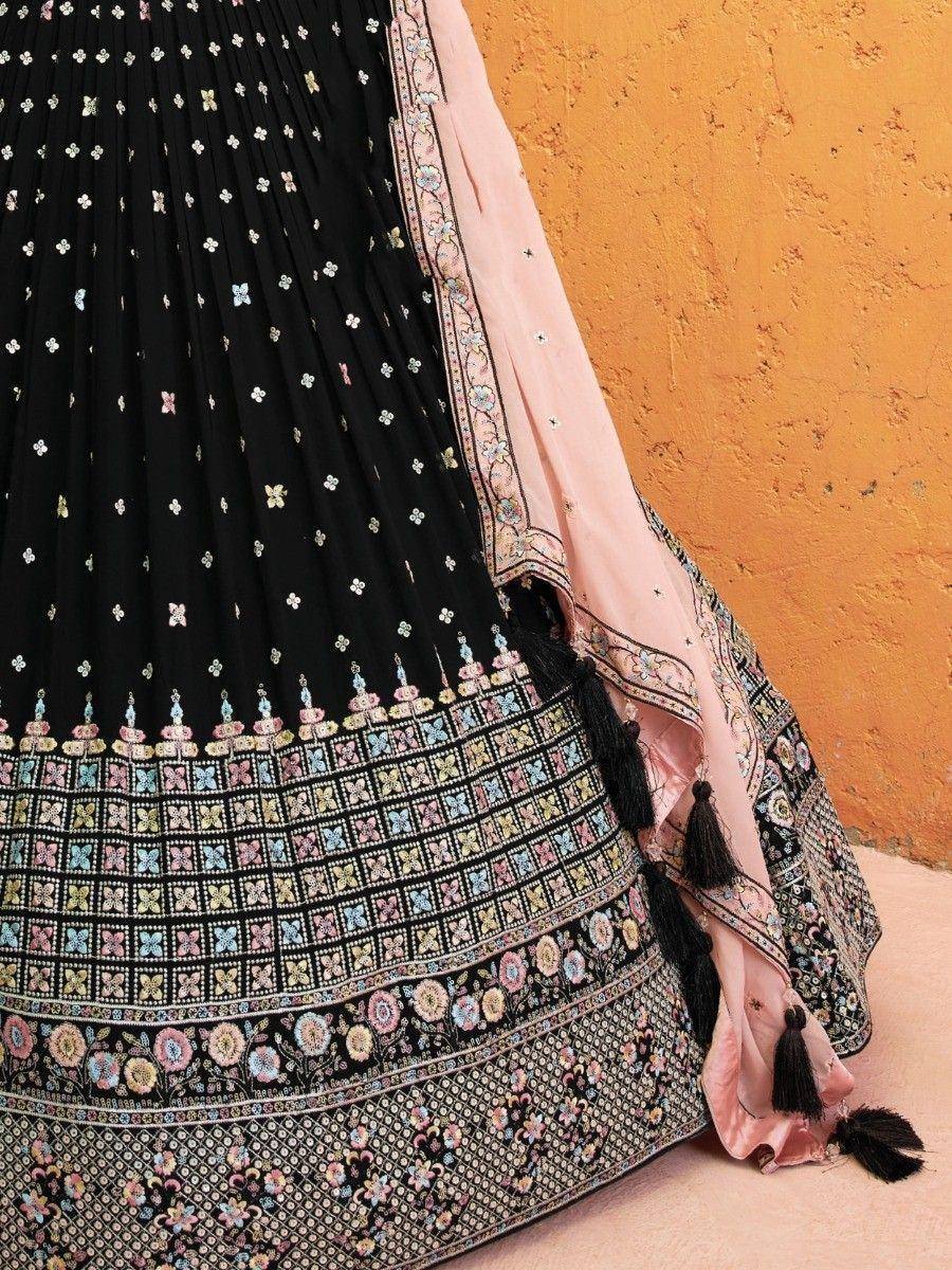 Black embroidered lehenga with pink dupatta, floral motifs, and tassels for Indian ethnic wear