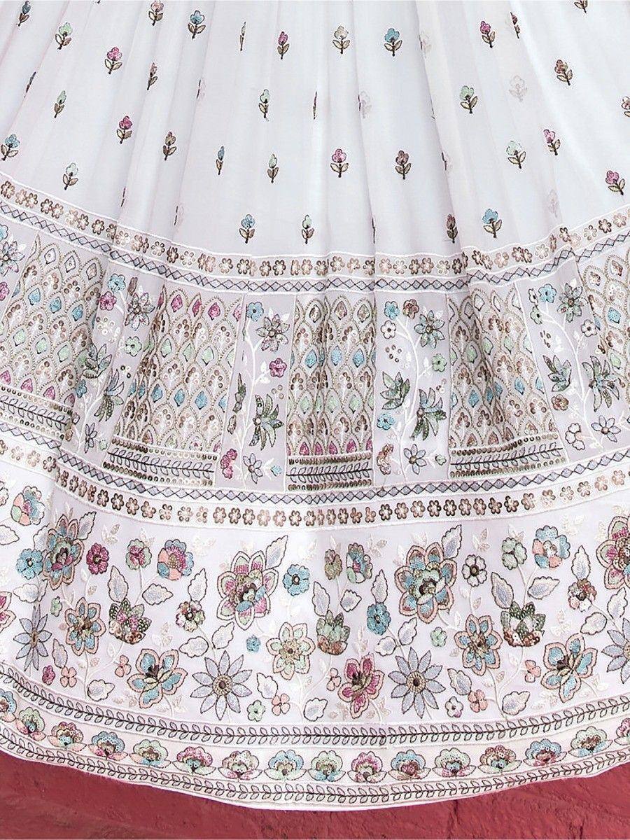 White embroidered lehenga with floral motifs and intricate border detailing, perfect for ethnic wear