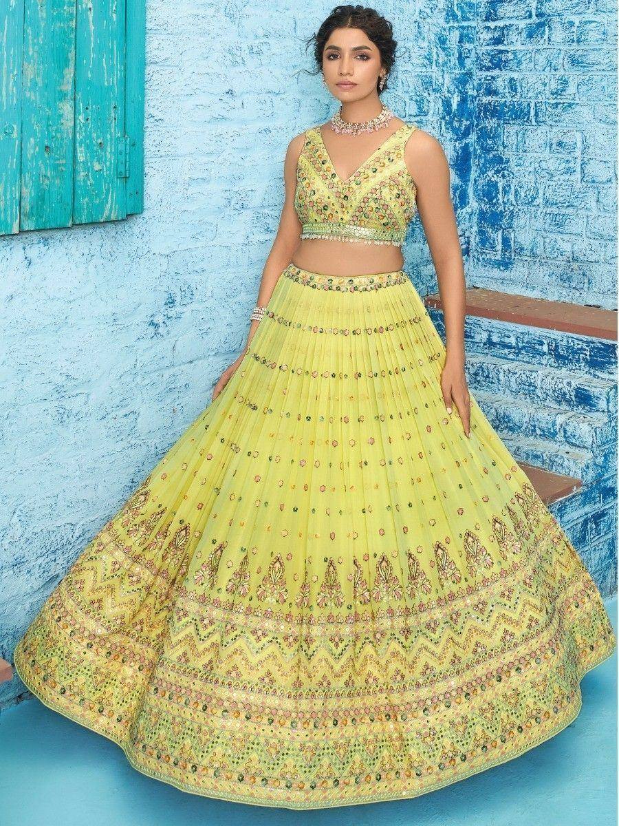 Yellow embroidered lehenga choli with floral motifs, perfect for Indian ethnic wear occasions