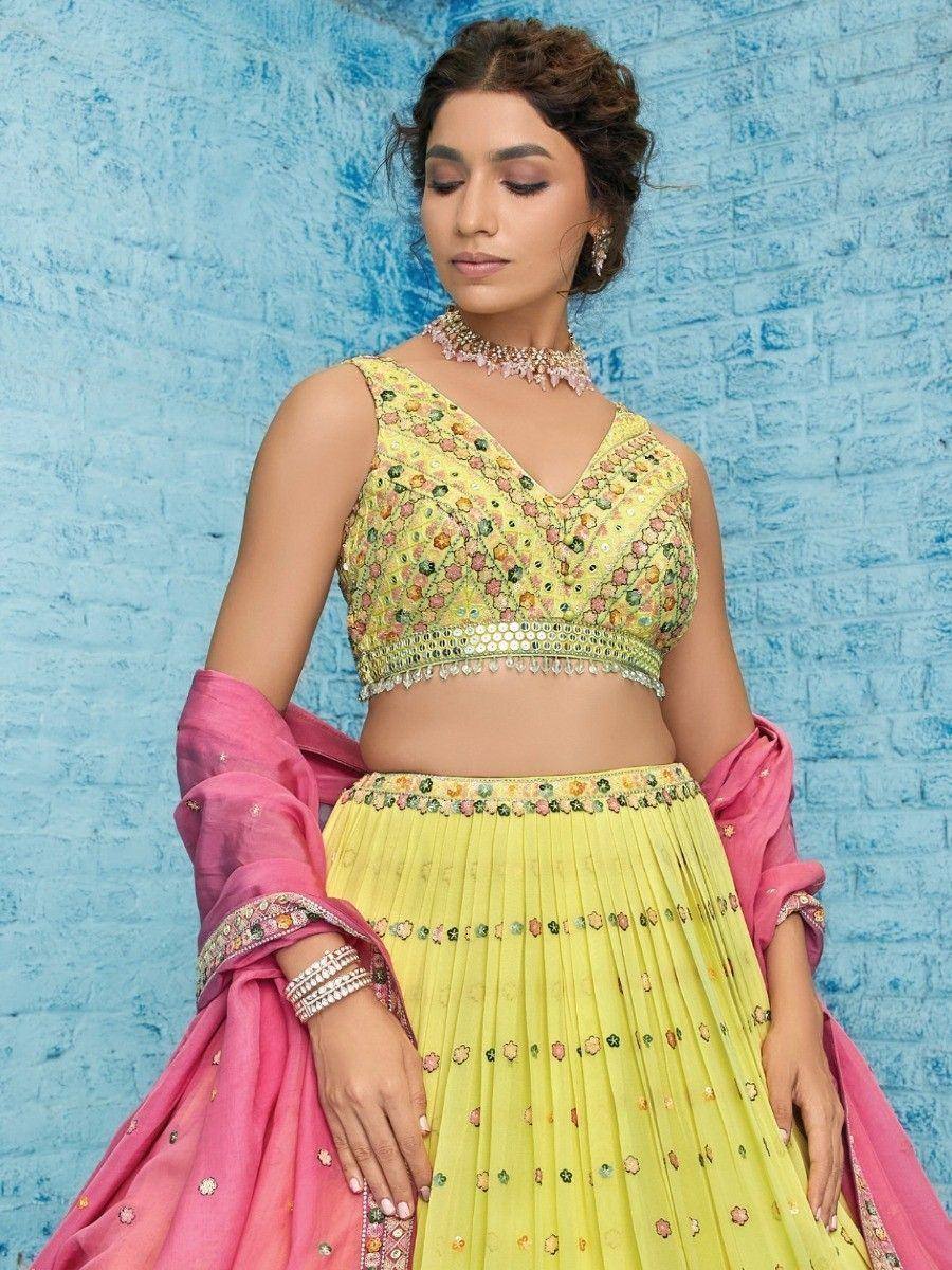 Yellow floral embroidered lehenga choli with pink dupatta, perfect for Indian weddings and festive occasions