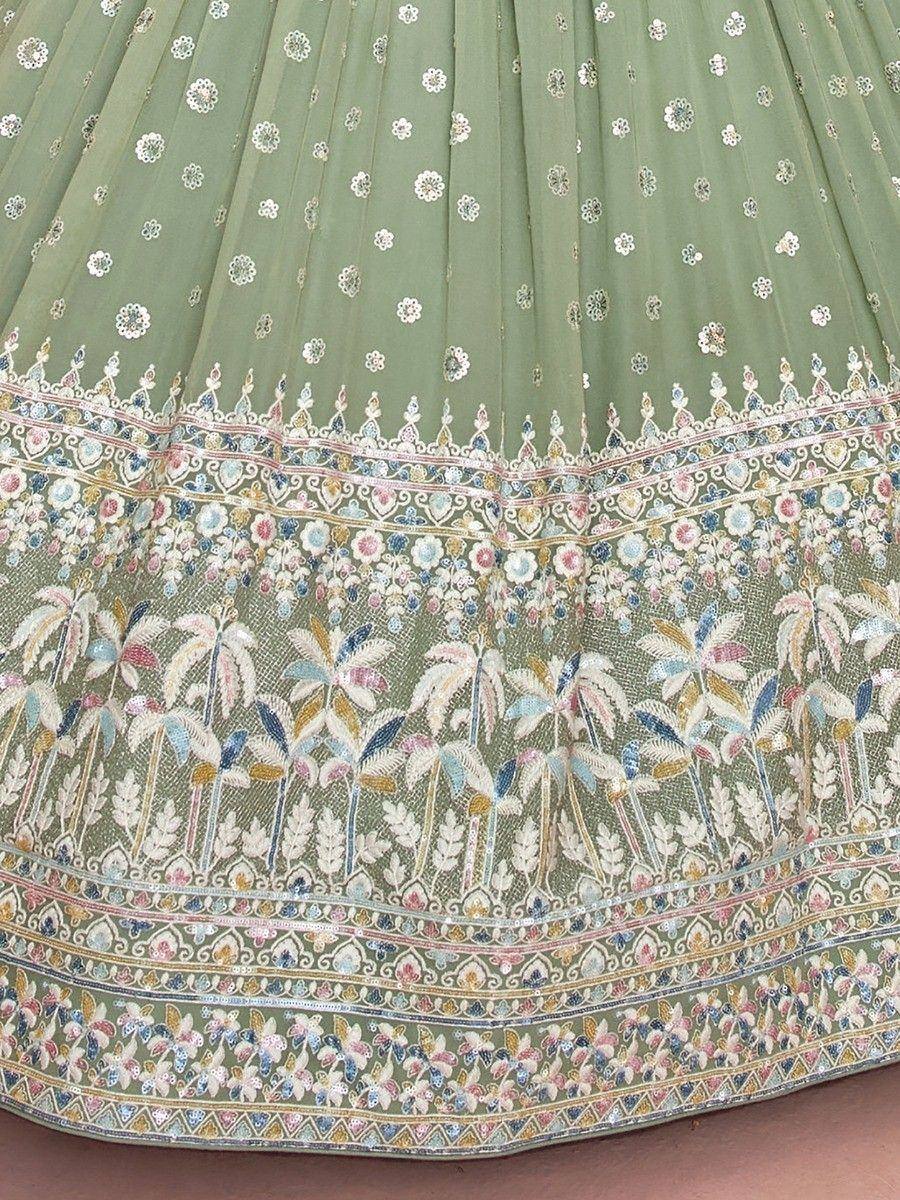 Green embroidered lehenga skirt with floral and palm tree motifs, perfect for Indian ethnic wear