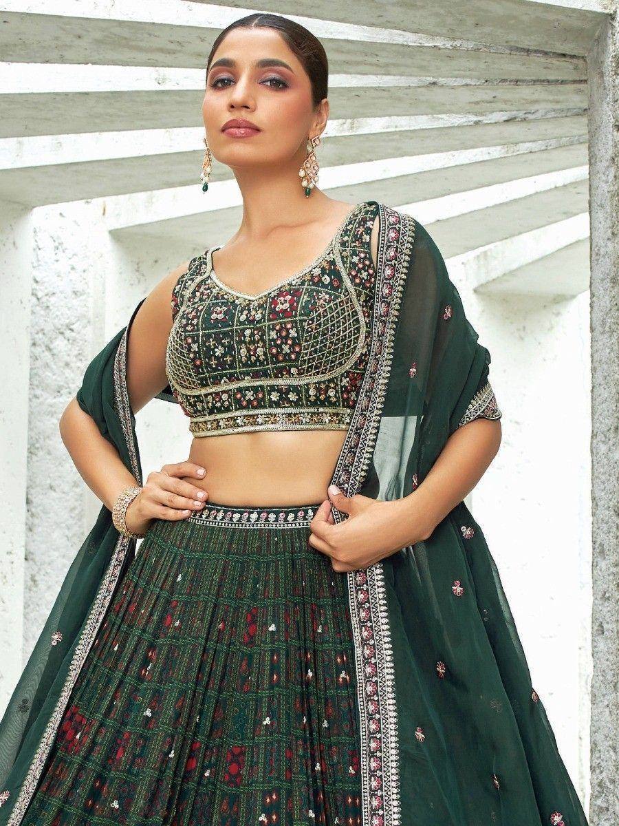 Emerald green embroidered lehenga choli with floral motifs and sheer dupatta, perfect for Indian ethnic occasions.