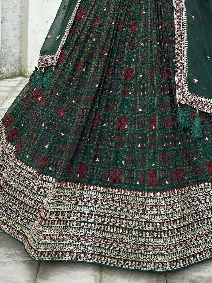 Green and red embroidered lehenga with intricate border and tassels, ethnic Indian wear