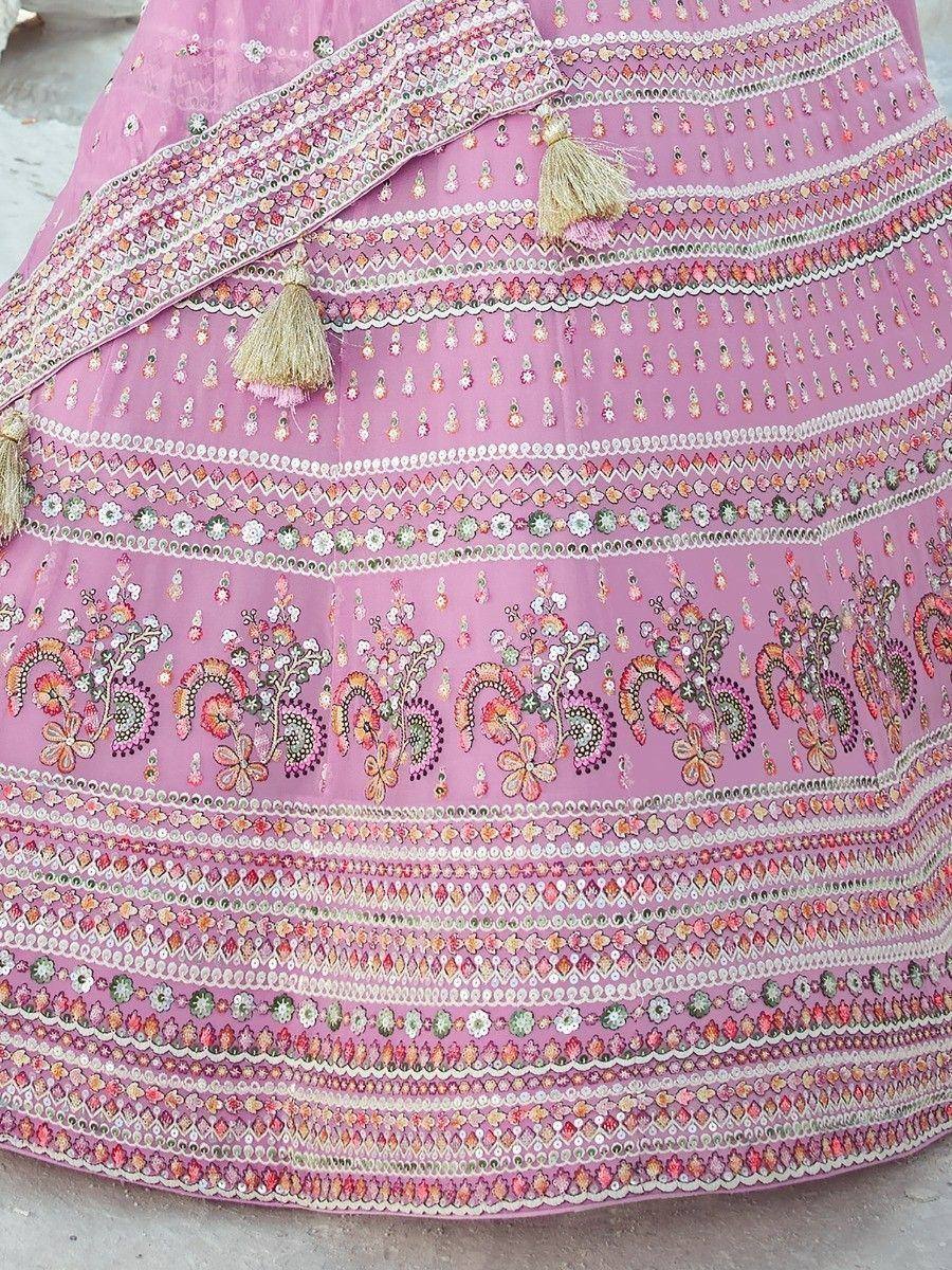 Pink embroidered lehenga with floral patterns and tassels, Indian ethnic wear