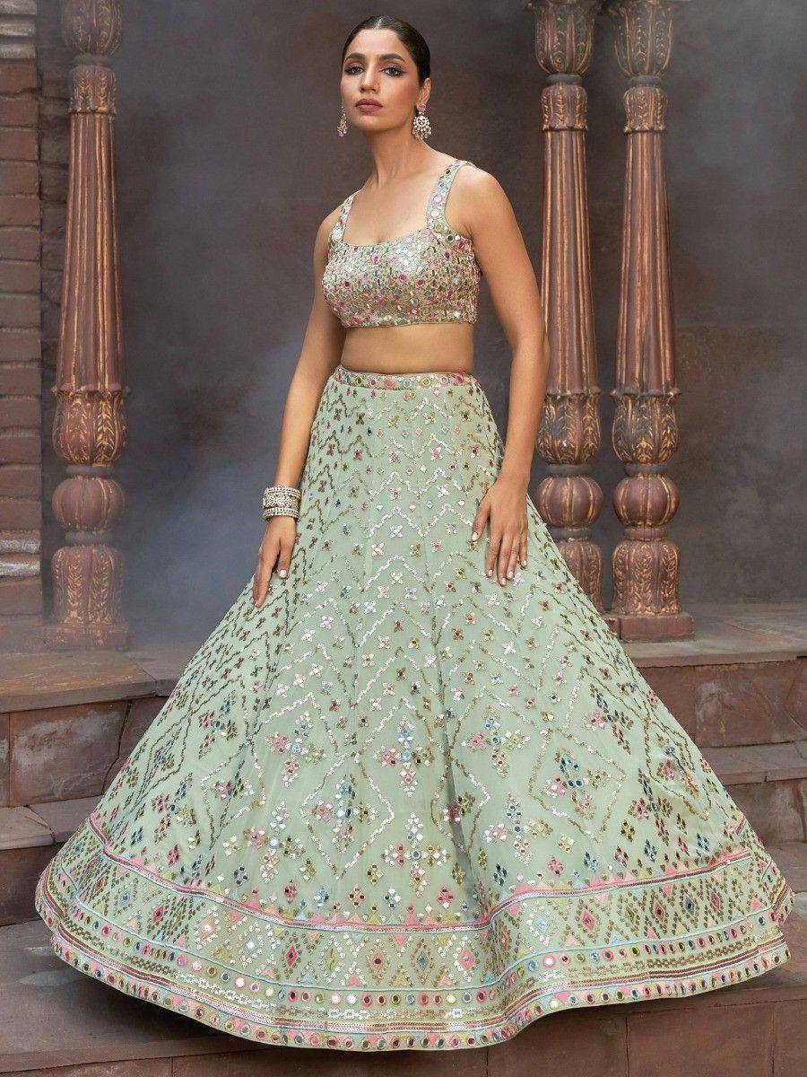 Mint green embroidered lehenga choli with floral mirror work, perfect for Indian weddings and festive occasions