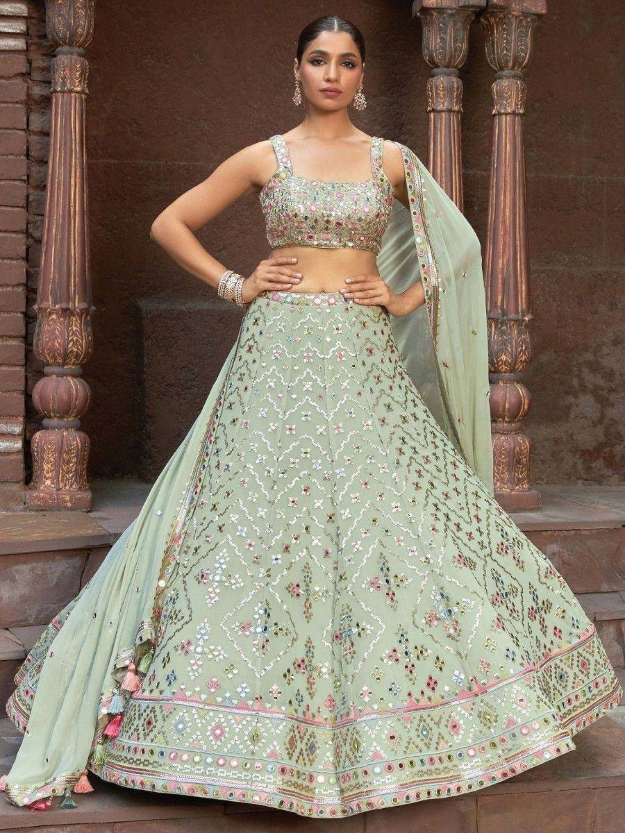 Mint green designer lehenga choli with intricate floral embroidery and mirror work, perfect for Indian weddings and festive occasions.