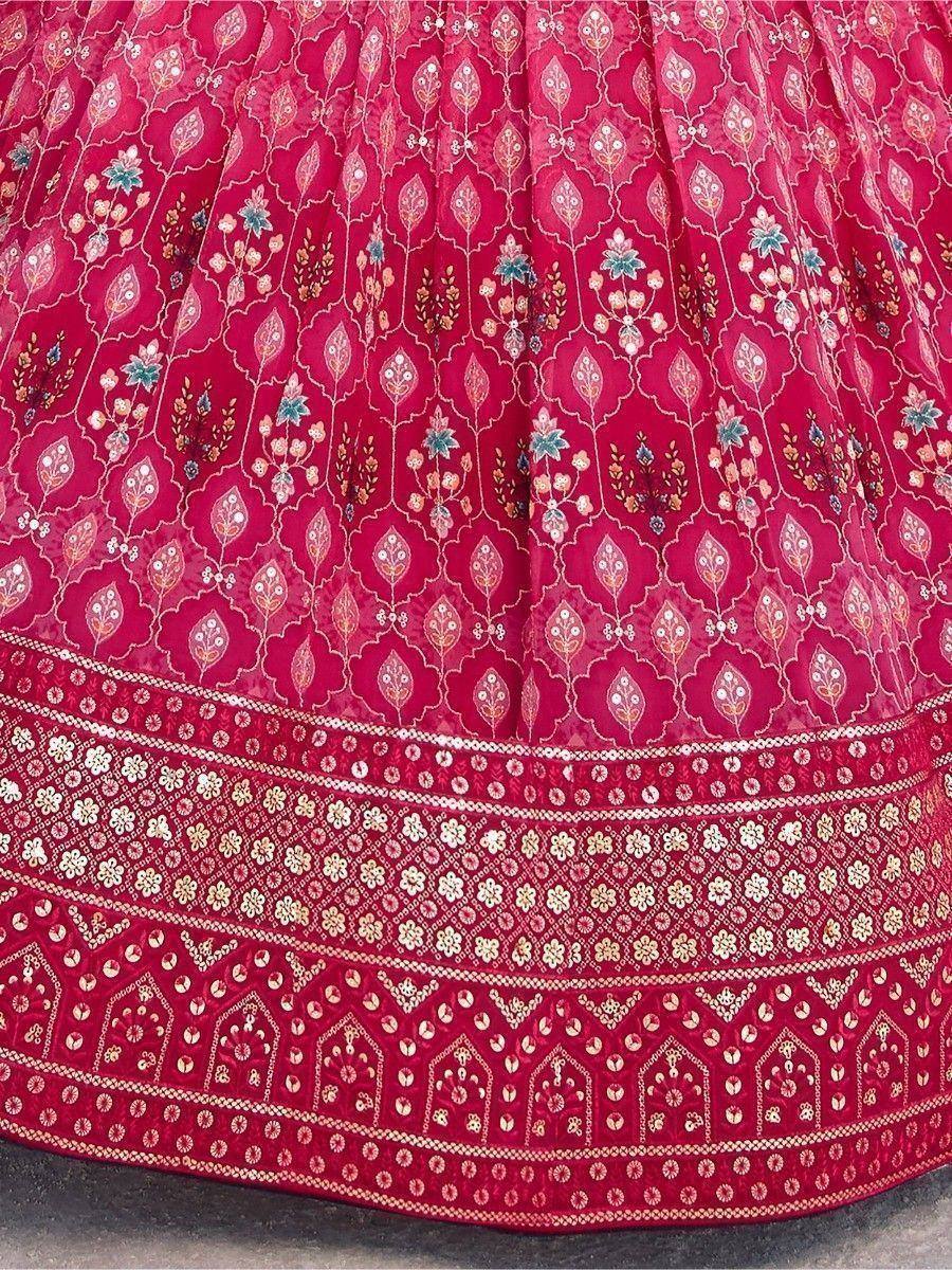 Rich red lehenga with intricate floral embroidery and detailed border work, perfect for Indian ethnic wear.