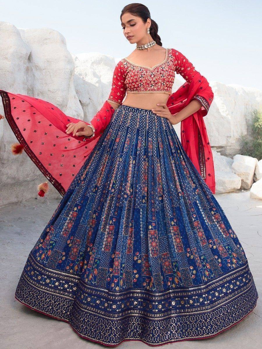 Red and blue embroidered lehenga choli with floral patterns, perfect for Indian ethnic wear occasions