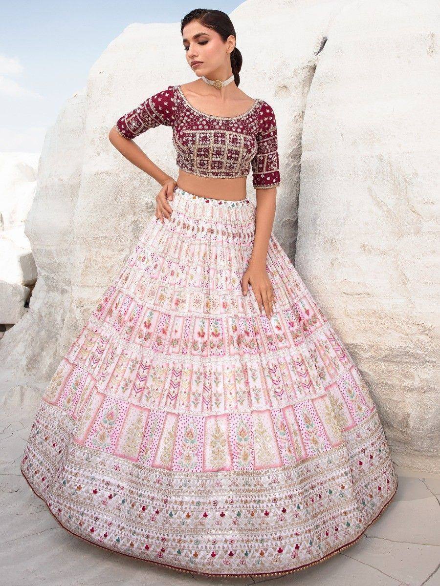 Maroon and pink embroidered lehenga choli with floral patterns, perfect for Indian ethnic wear occasions.