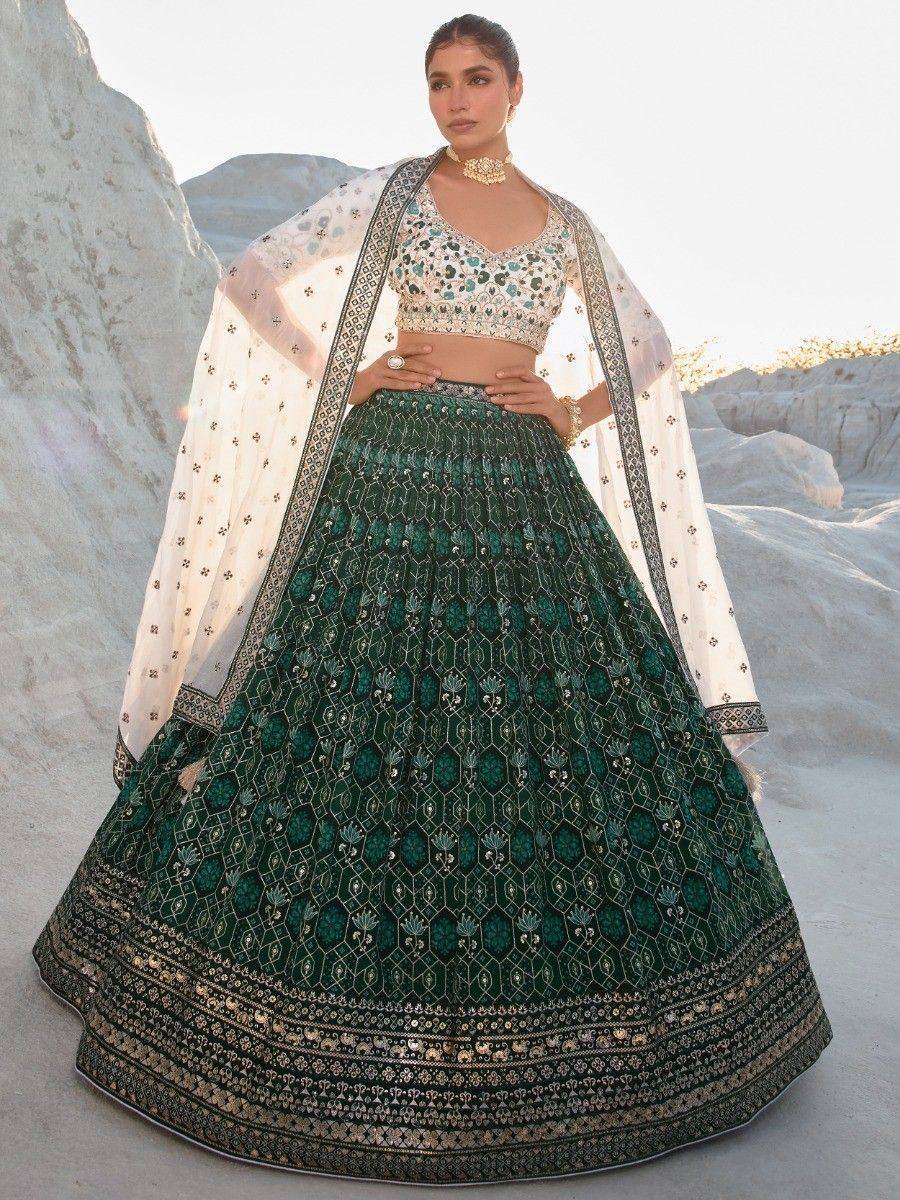Emerald green designer lehenga choli with intricate embroidery and sheer dupatta, perfect for Indian ethnic wear.