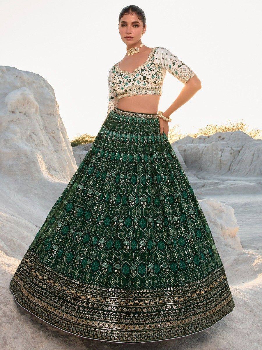 Emerald green embroidered lehenga choli with gold detailing, perfect for Indian weddings and festive occasions.