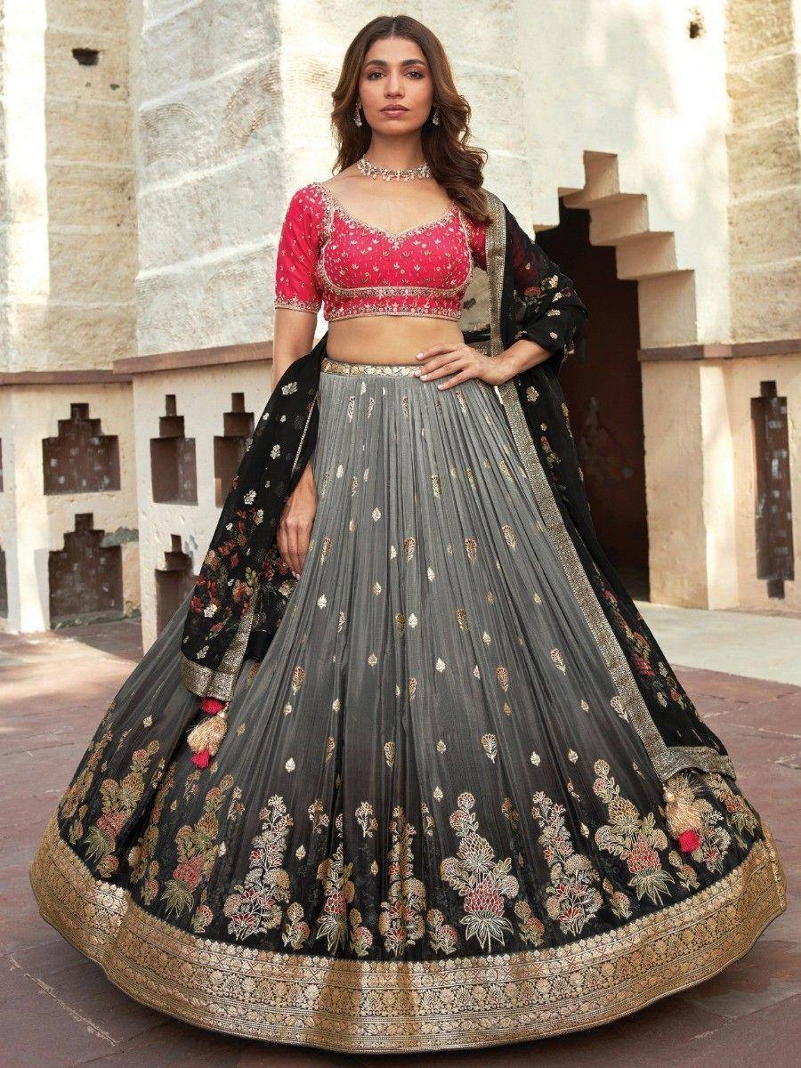 Red embroidered blouse with grey and black floral lehenga choli, perfect for Indian weddings and festive occasions.