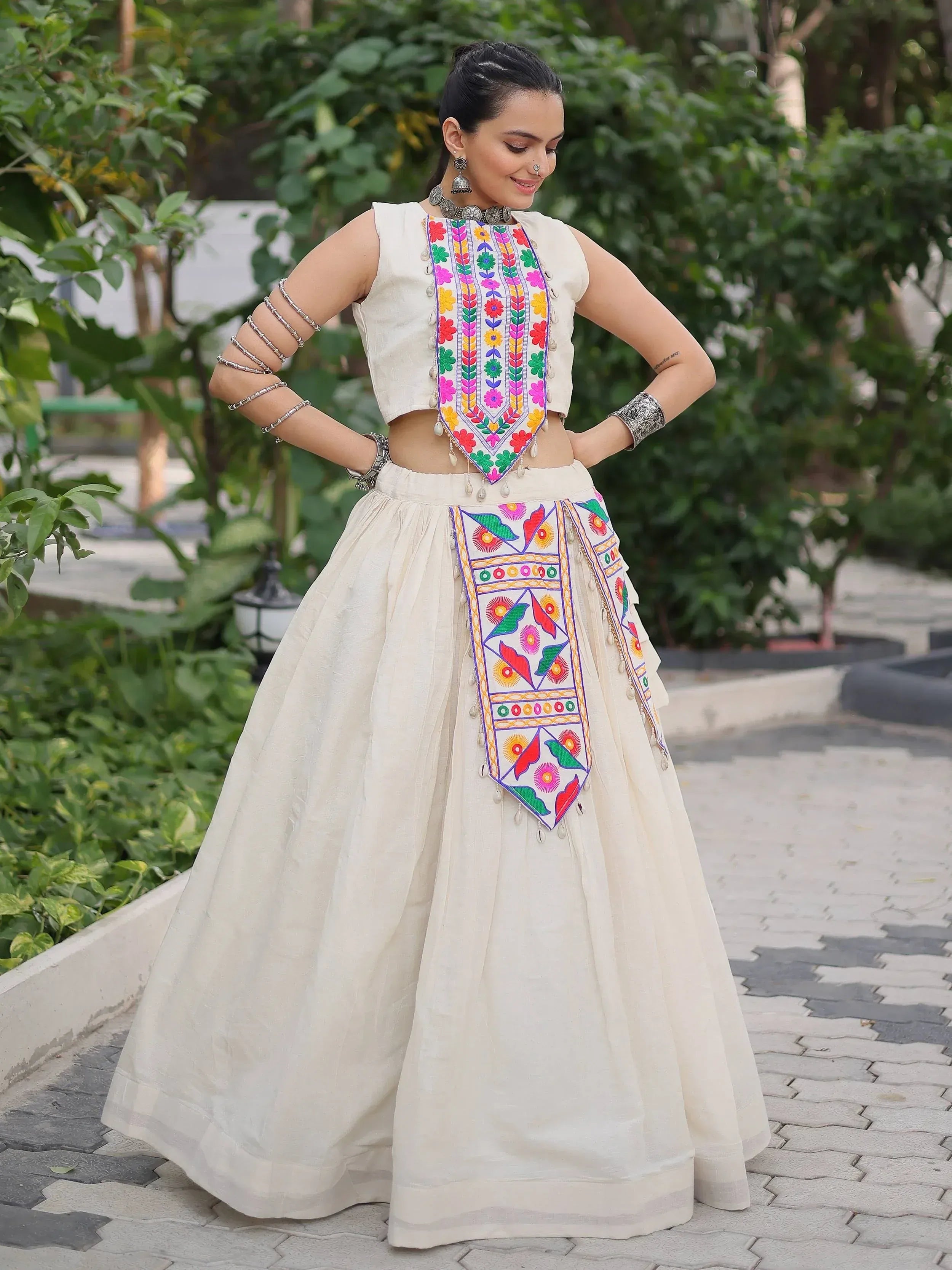 Cream ethnic lehenga choli with colorful floral embroidery, perfect for Indian weddings and festivals.
