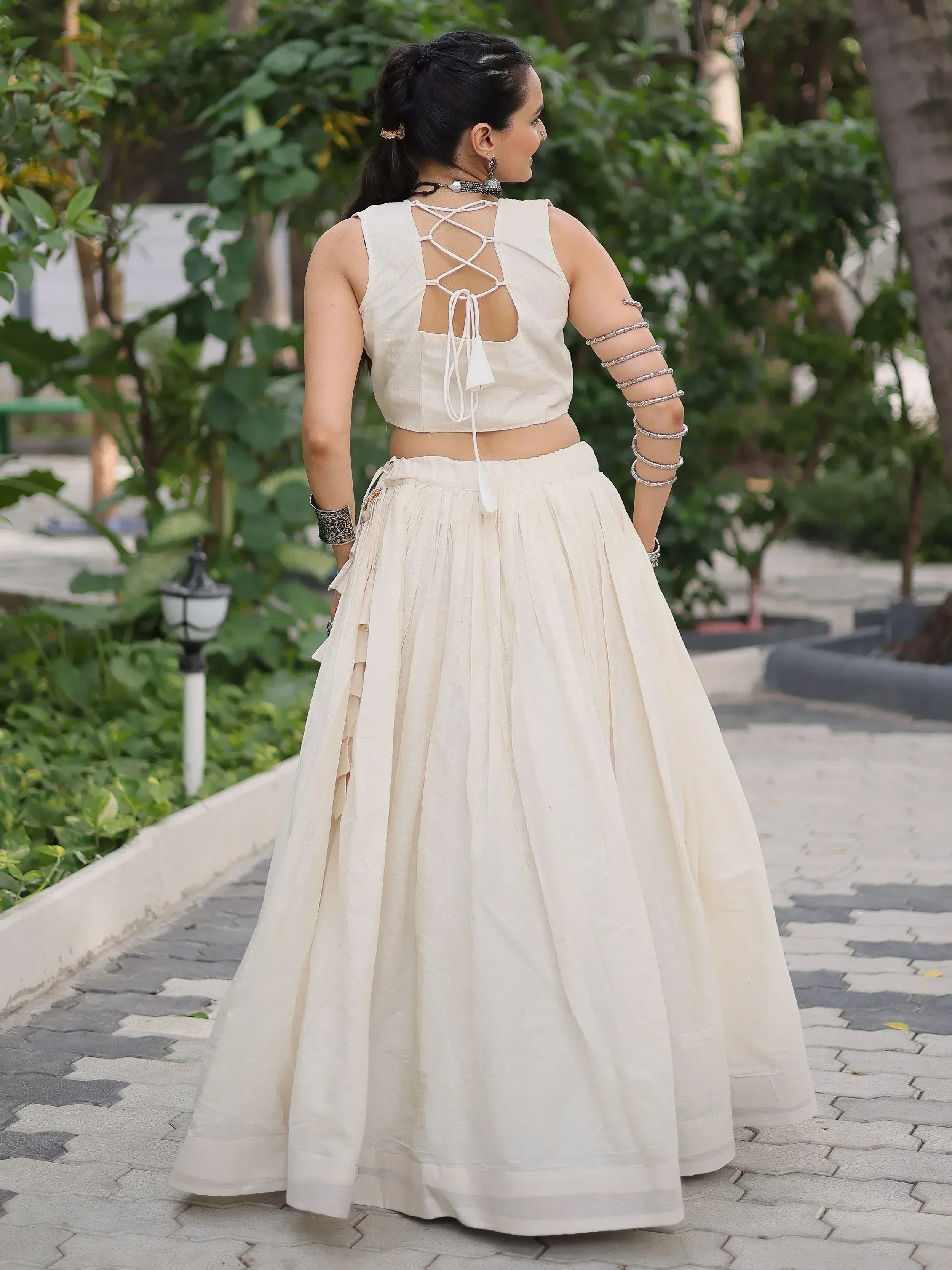 Elegant off-white lehenga choli with crisscross back design, perfect for Indian ethnic wear