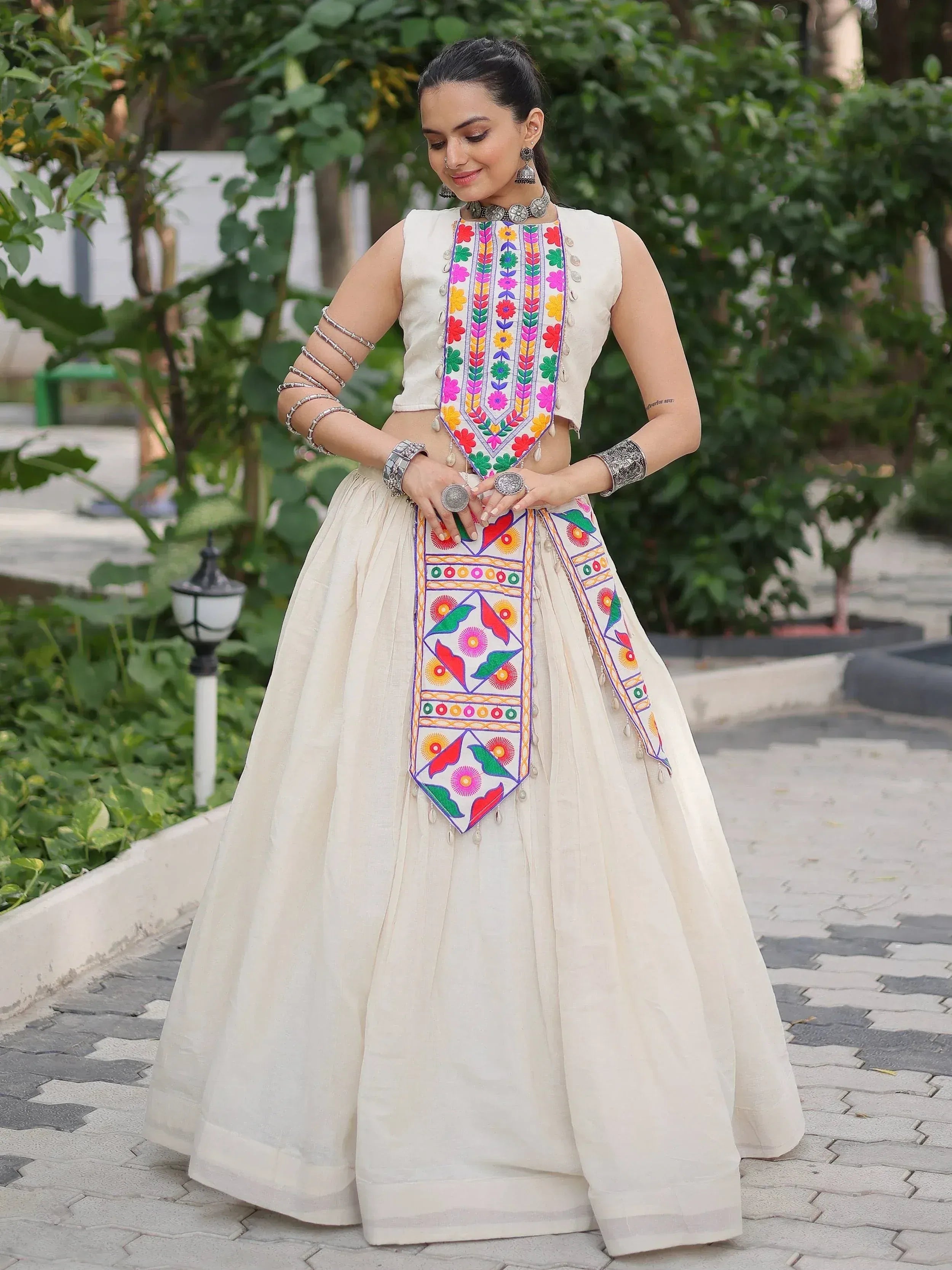 White ethnic lehenga choli with colorful floral embroidery, perfect for Indian festive occasions