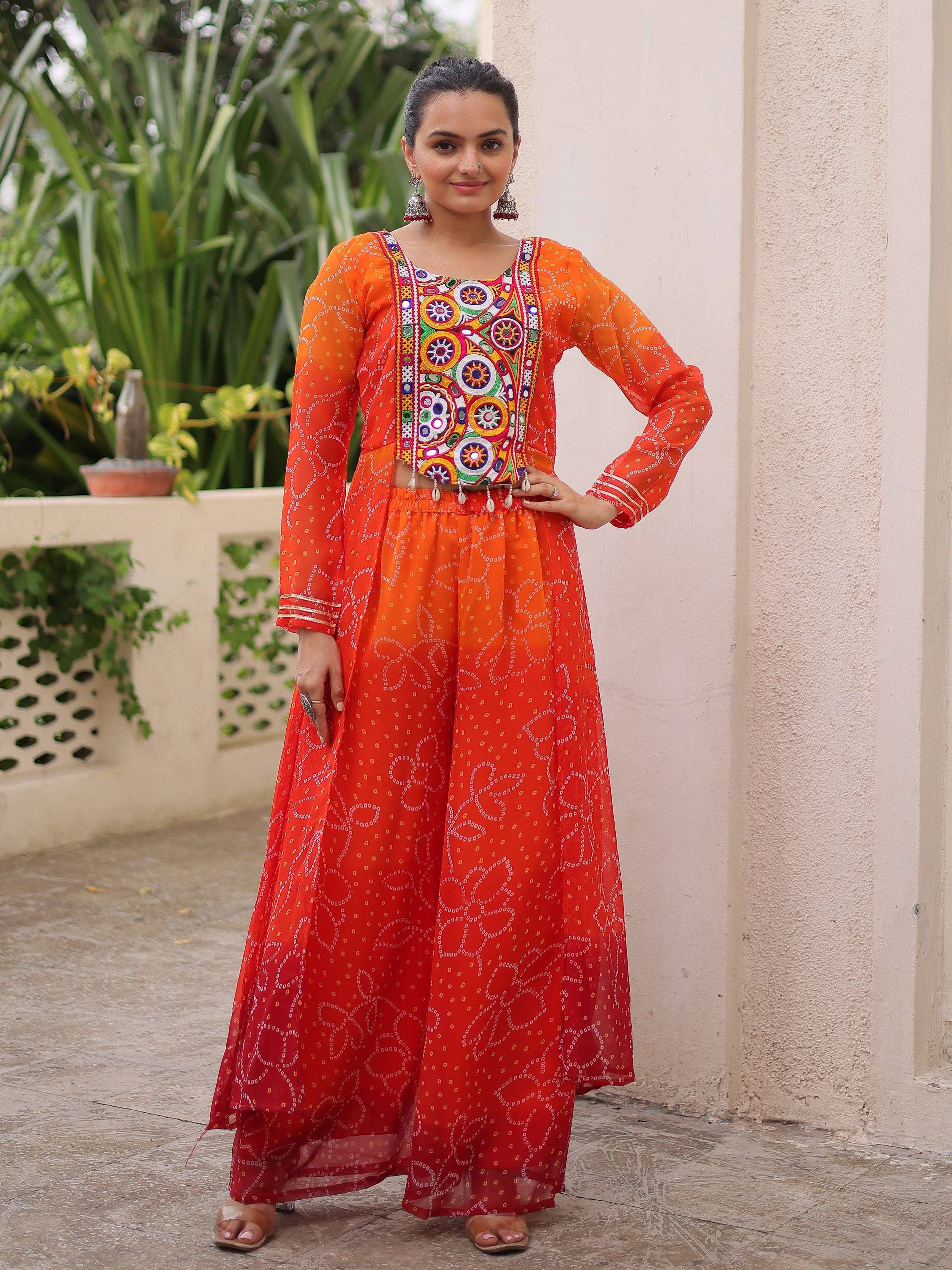 Orange embroidered ethnic gown with mirror work, perfect for Indian festivals and parties