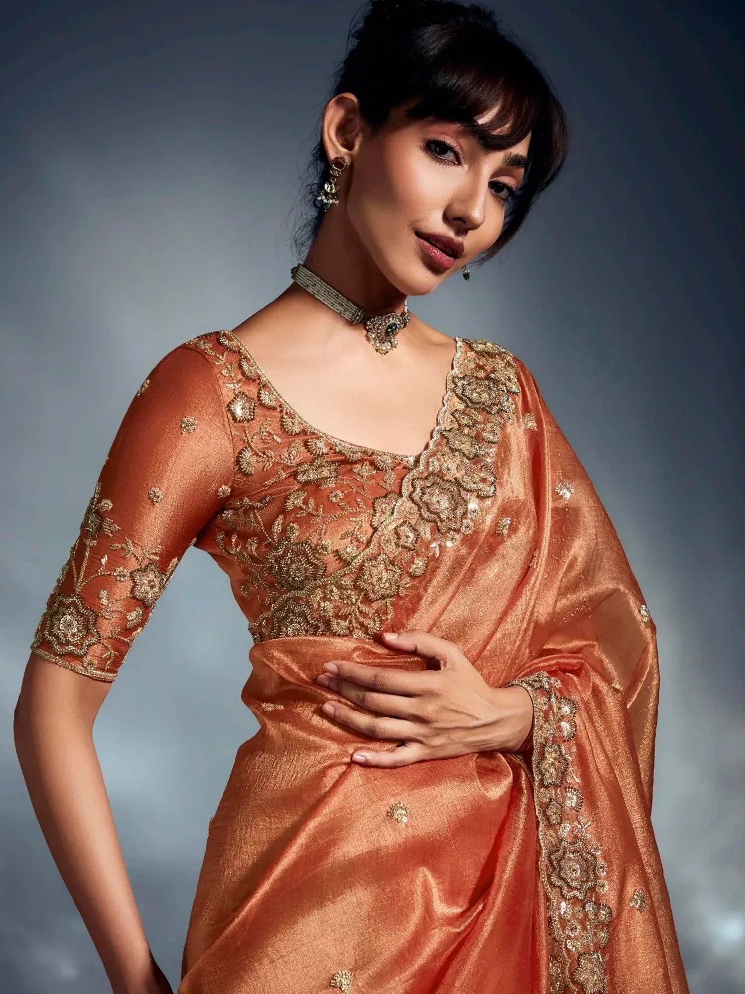 Elegant peach saree with gold floral embroidery, perfect for Indian ethnic wear occasions