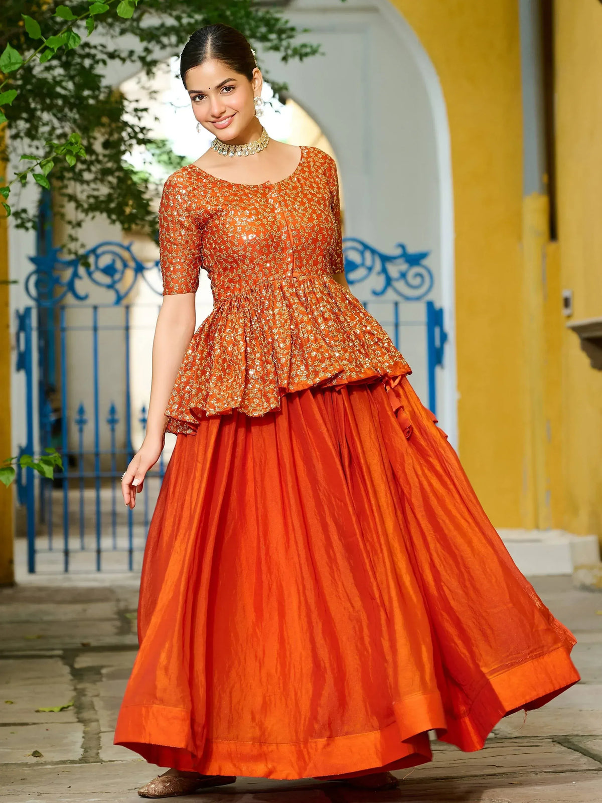 Orange embroidered lehenga choli with peplum top and flared skirt, perfect for Indian ethnic occasions