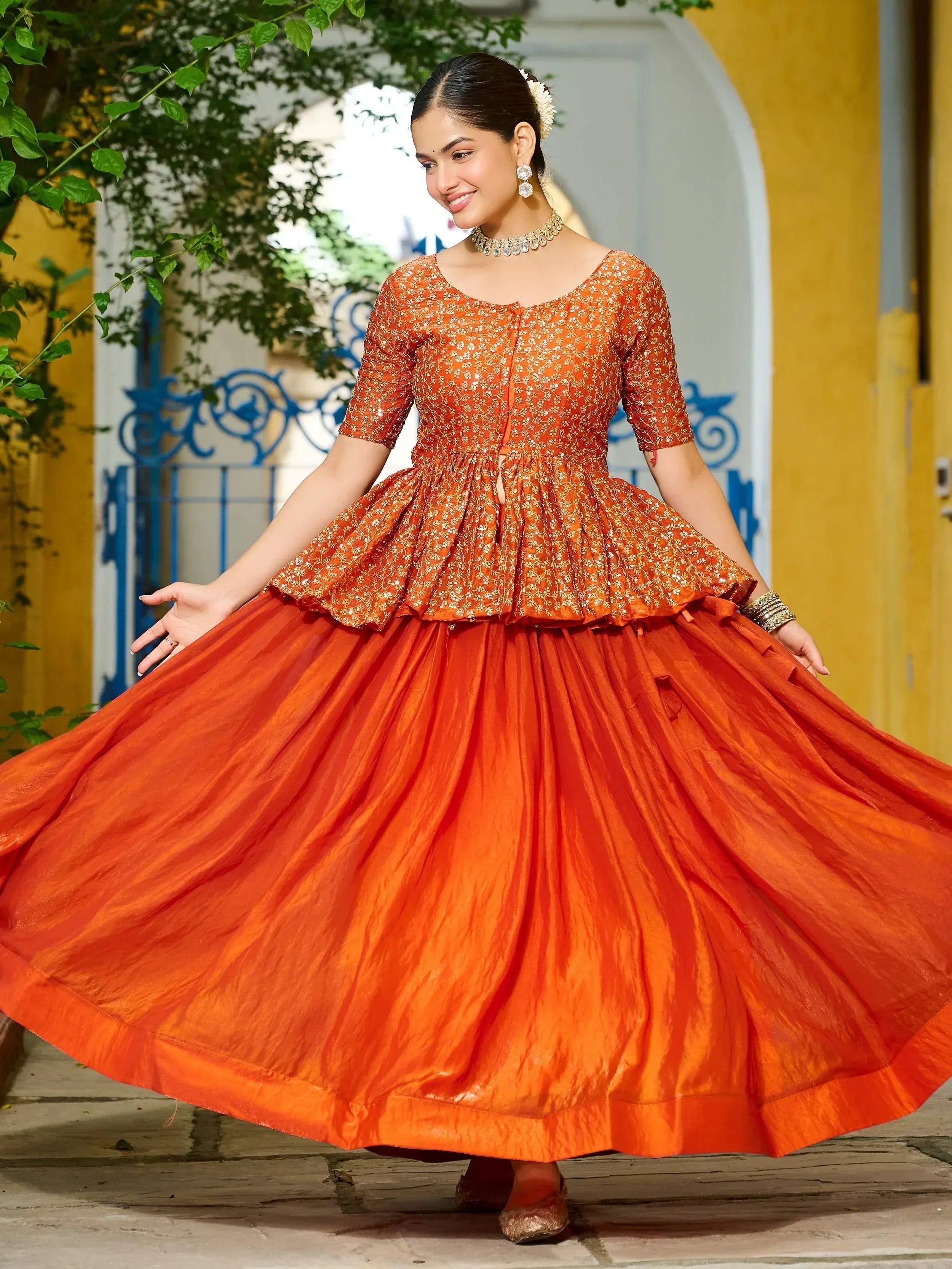 Orange embroidered ethnic gown with flared skirt, perfect for Indian festivals and weddings