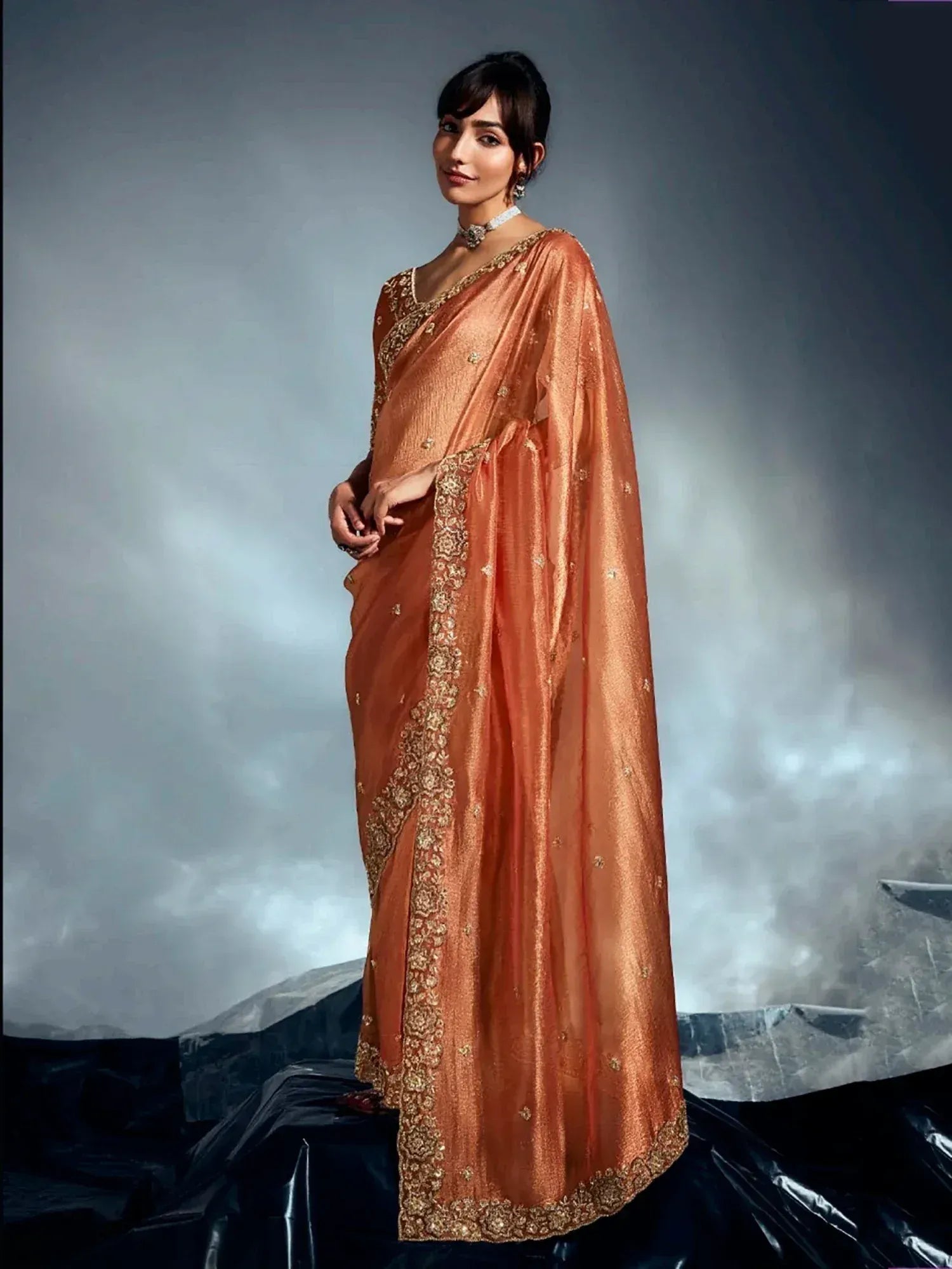 Elegant peach saree with gold embroidery, perfect for Indian ethnic wear occasions