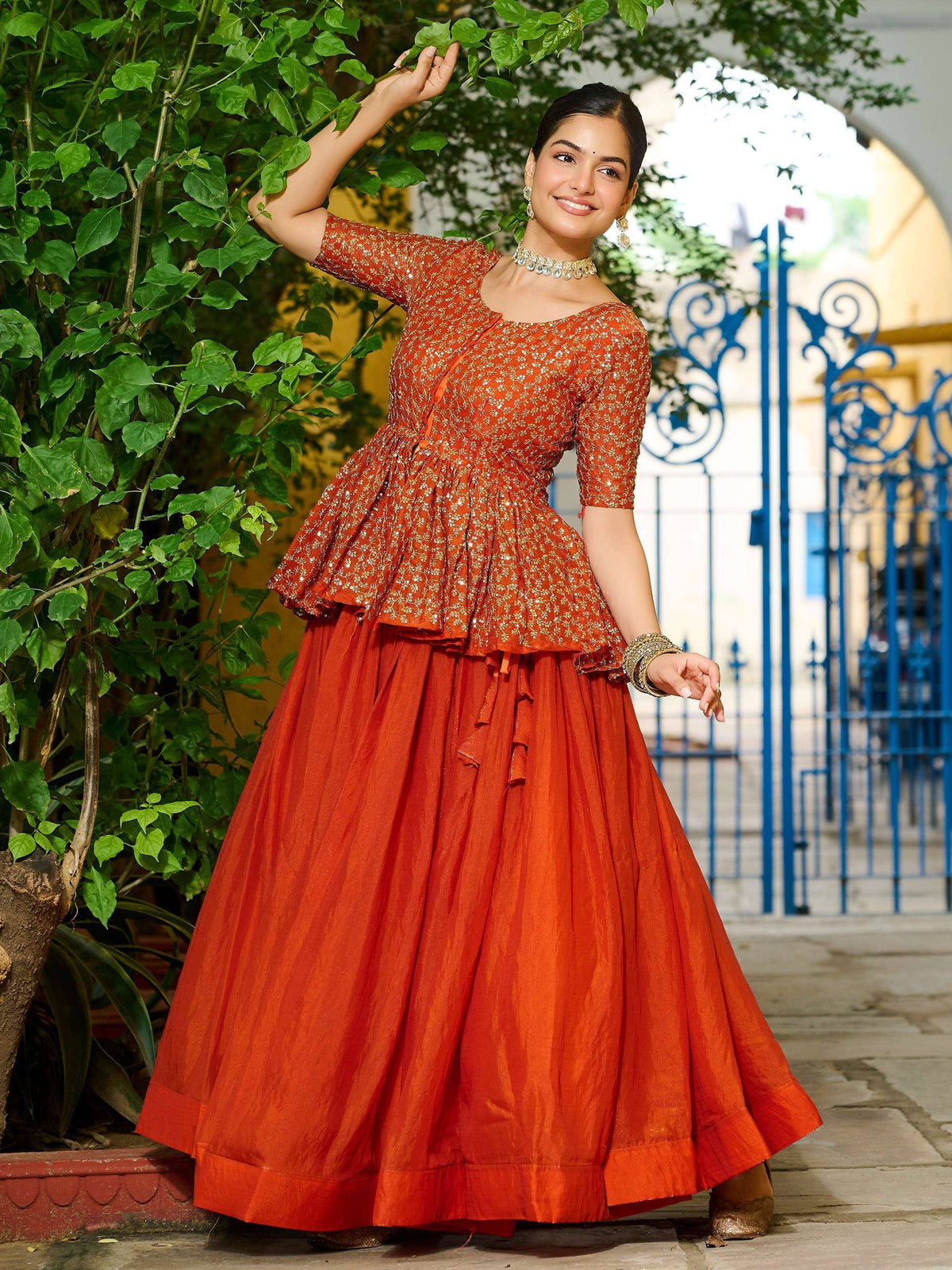 Orange embroidered lehenga choli with peplum top, perfect for Indian ethnic wear and festive occasions.