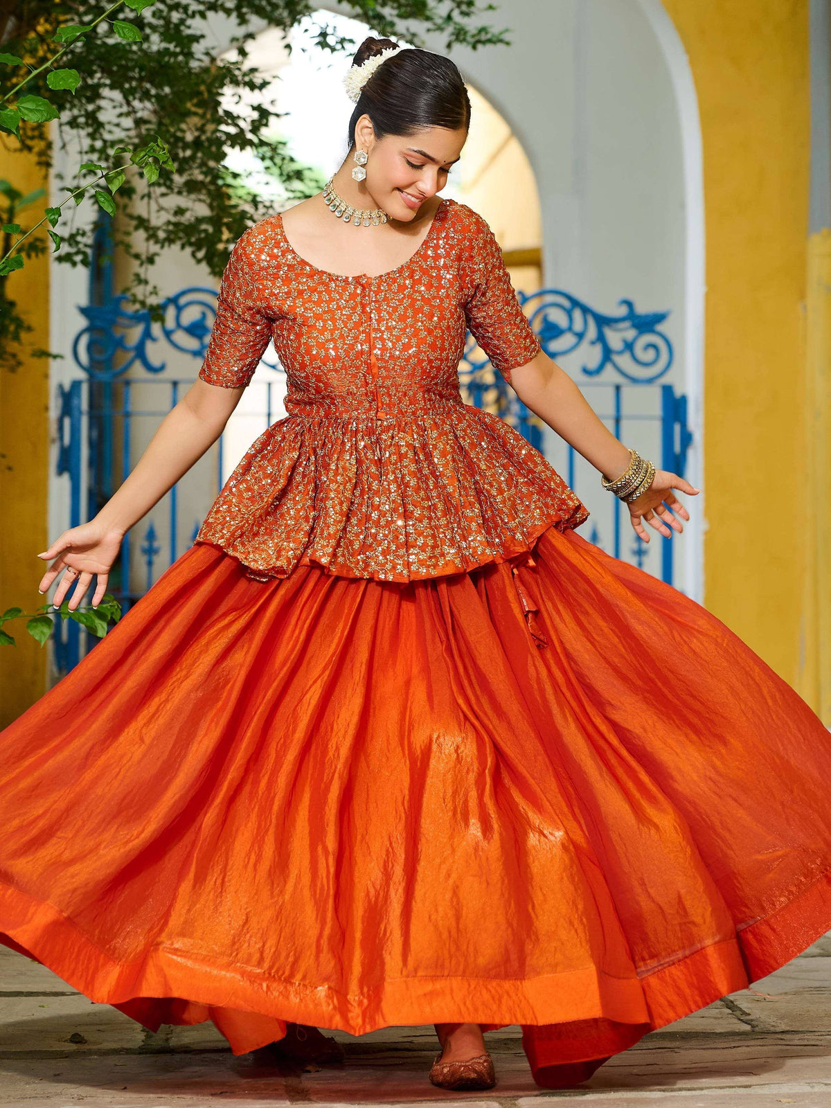 Orange embroidered lehenga choli with flared skirt, perfect for Indian ethnic wear and festive occasions
