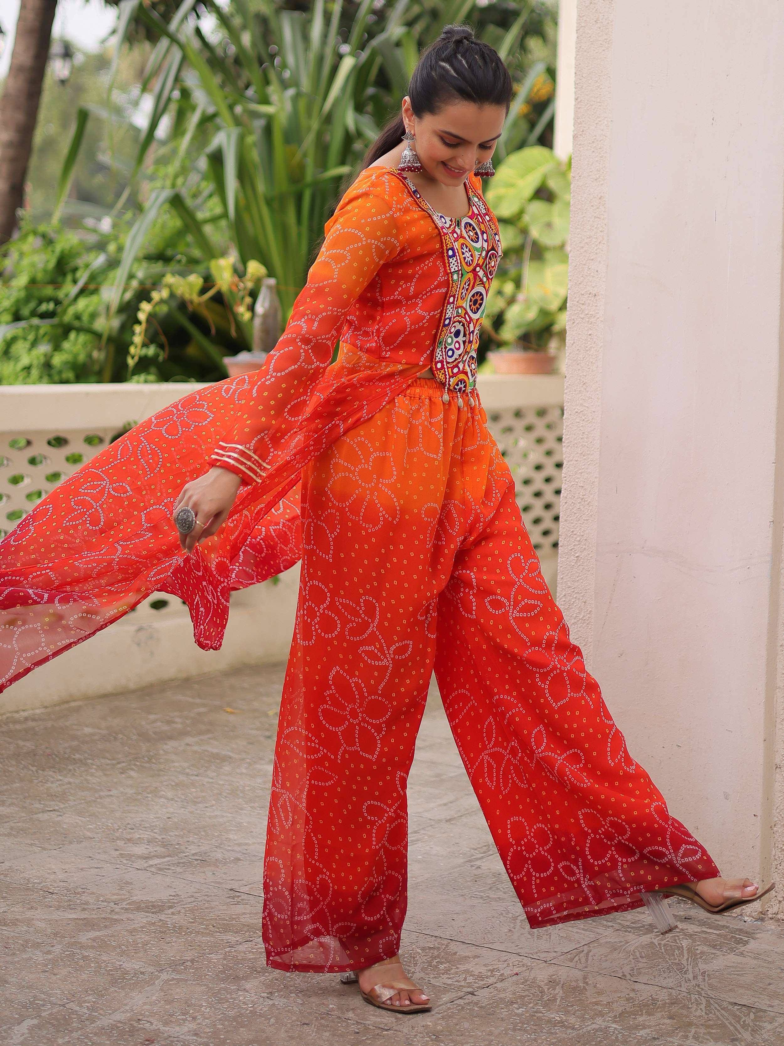 Orange printed ethnic palazzo suit with embroidered top and flared pants for women
