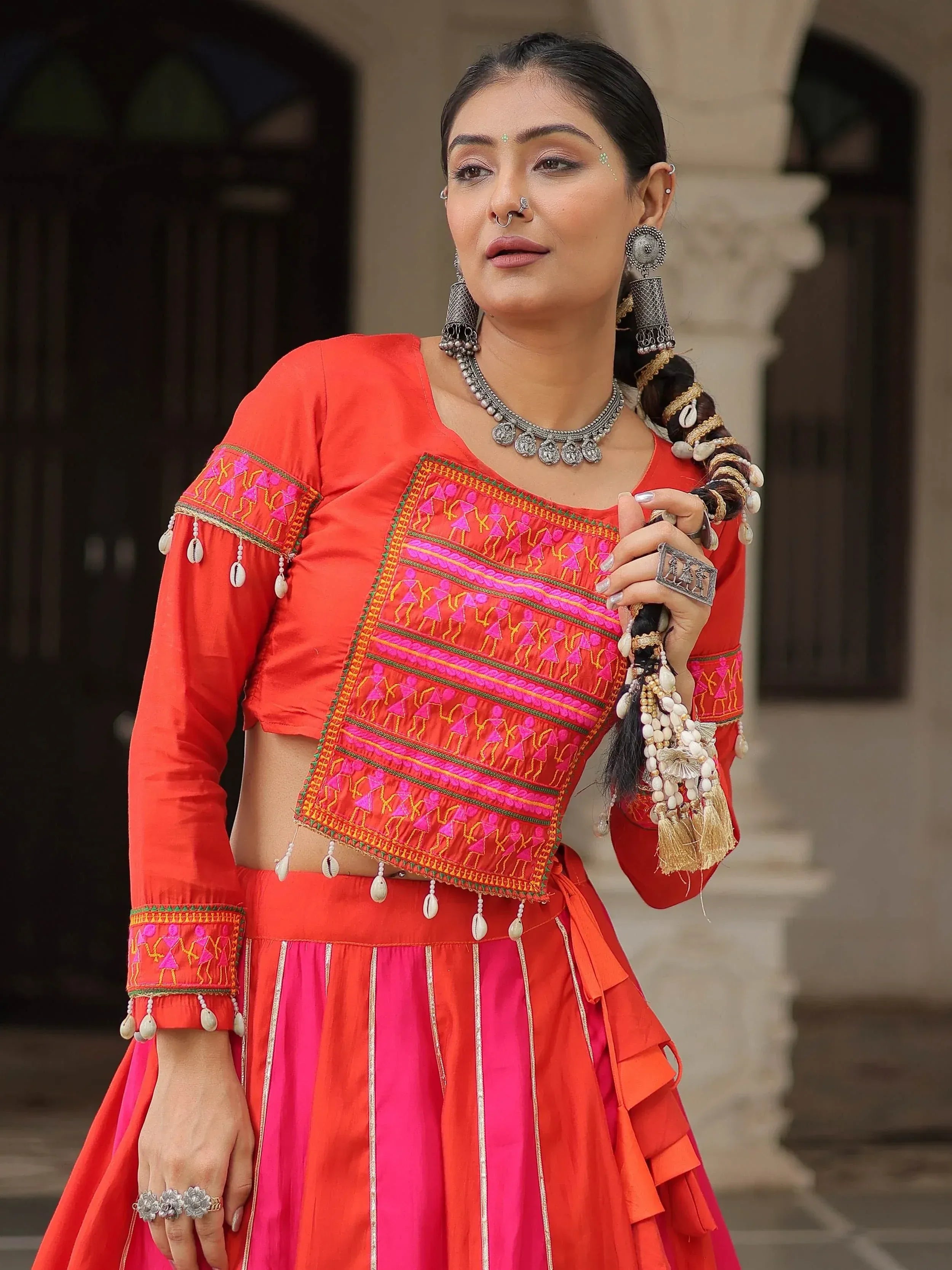 Vibrant red and pink embroidered lehenga choli with mirror work, traditional Indian ethnic wear