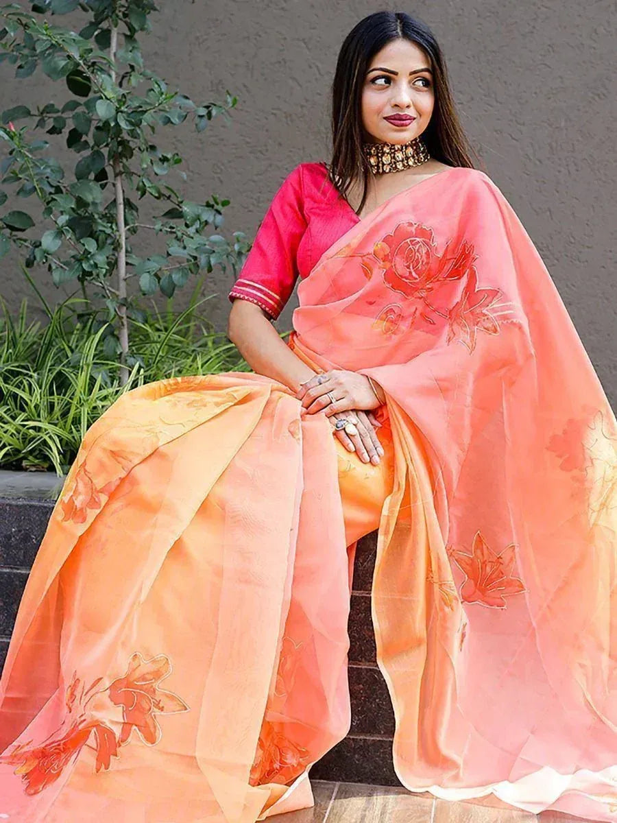 Woman in peach floral saree with pink blouse, ethnic Indian wear for festive occasions