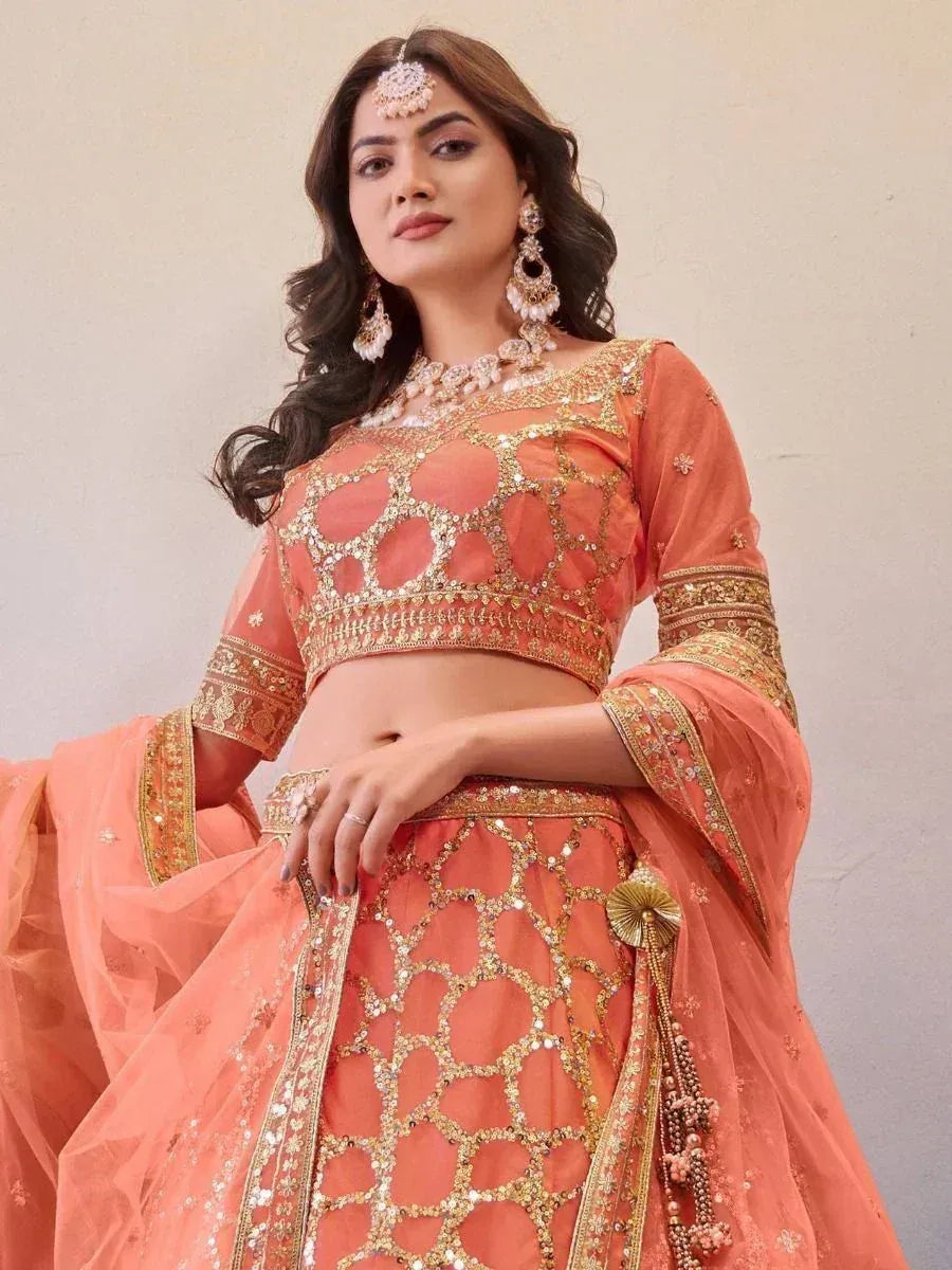 Peach designer lehenga choli with gold embroidery and mirror work, perfect for Indian weddings and festive occasions