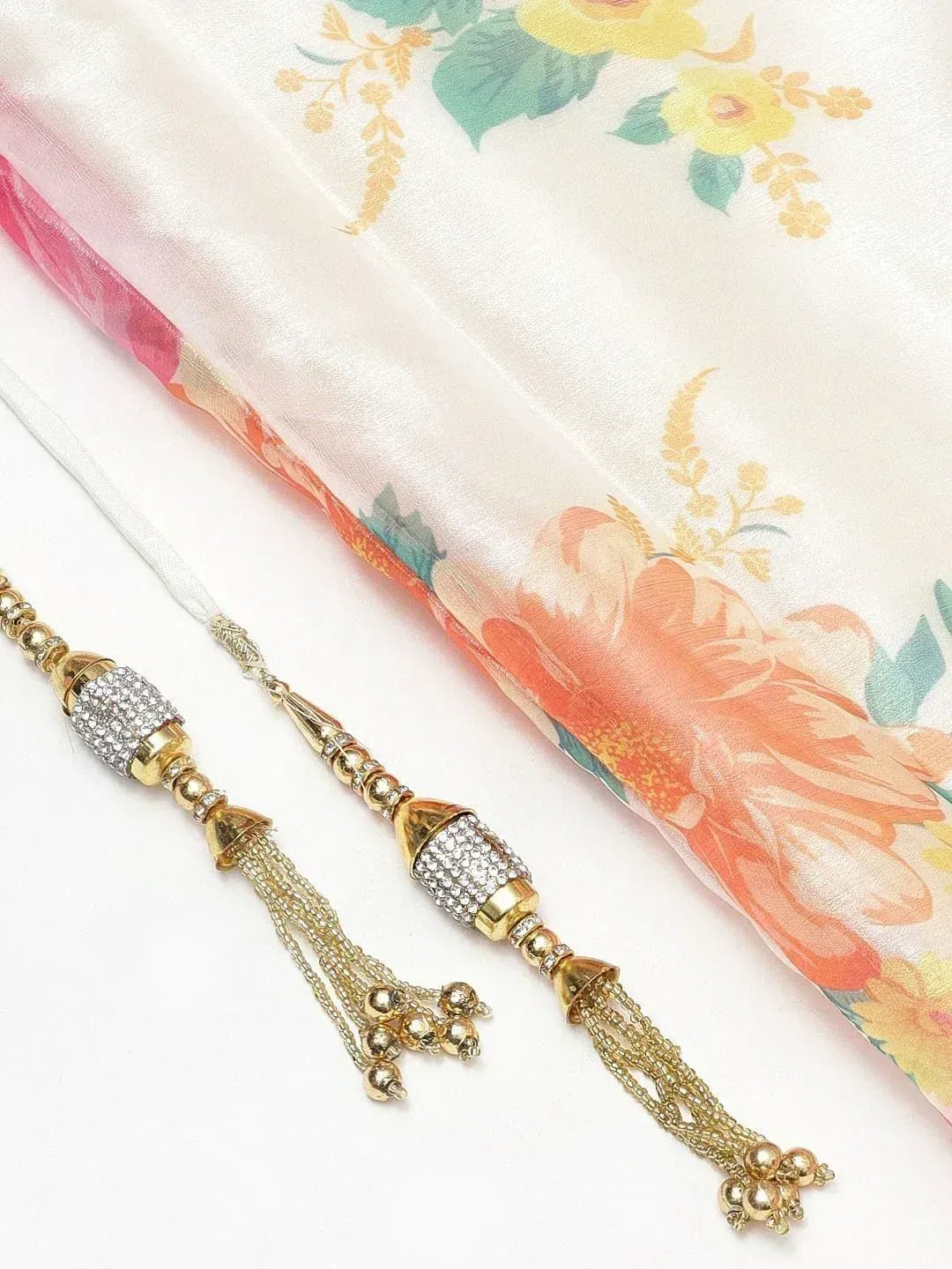 Elegant gold tassels with crystal beads for ethnic wear, paired with floral silk dupatta