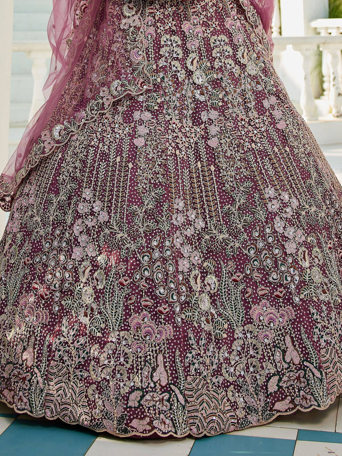 Elegant maroon lehenga with intricate floral embroidery and sequin detailing, perfect for Indian ethnic wear.