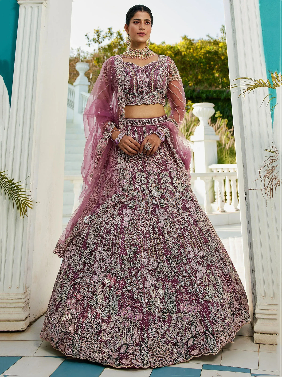 Elegant purple embroidered lehenga choli with sheer dupatta, perfect for Indian weddings and festive occasions.
