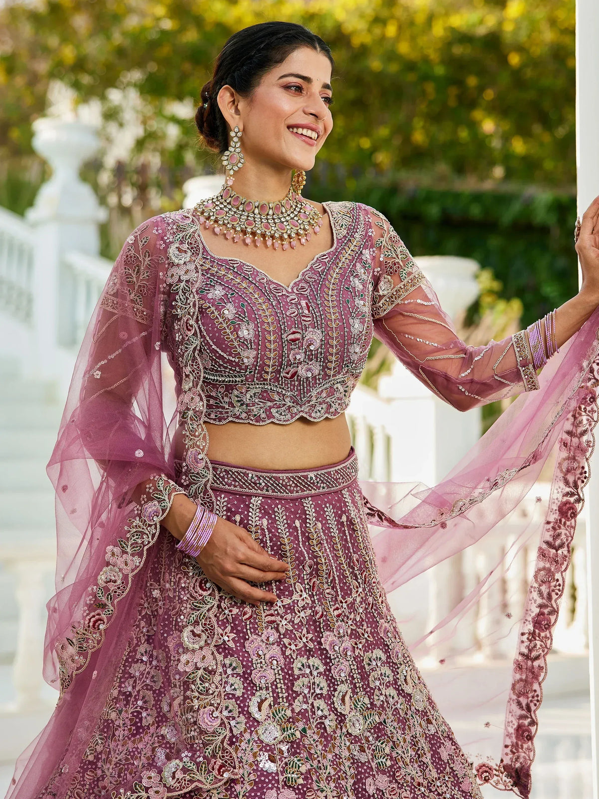 Elegant mauve embroidered lehenga choli with sheer sleeves and floral detailing, perfect for Indian ethnic occasions.