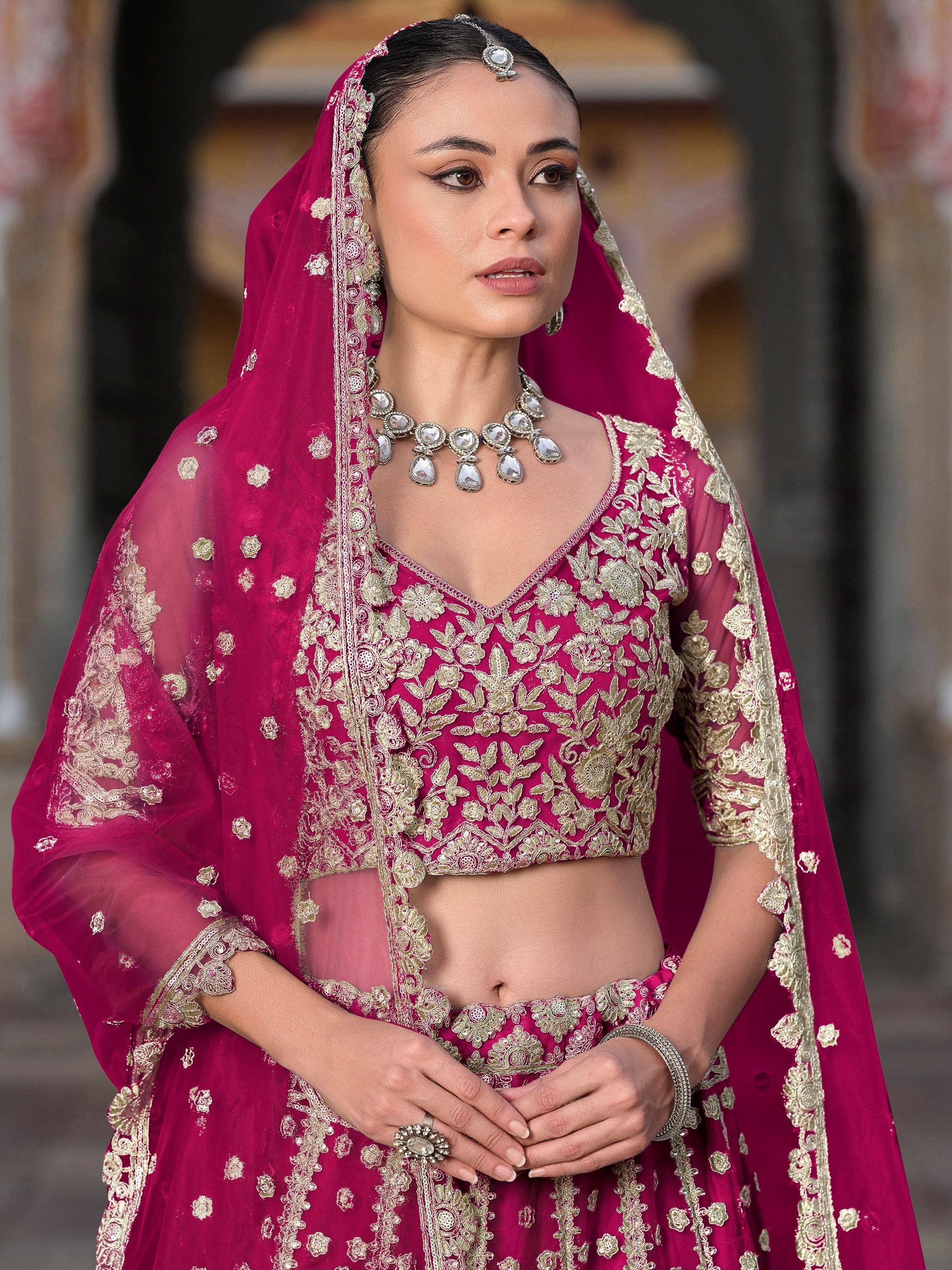 Elegant magenta lehenga choli with gold embroidery, perfect for Indian weddings and festive occasions.