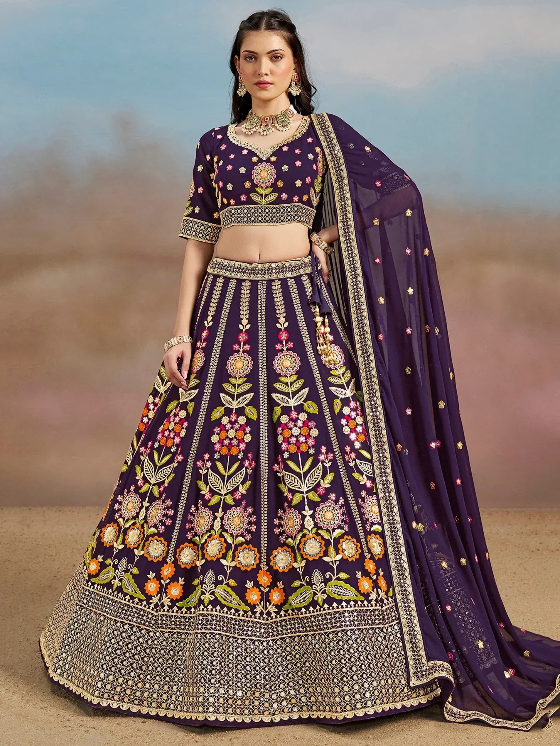 Purple embroidered lehenga choli with floral motifs and gold detailing, perfect for Indian ethnic wear occasions.