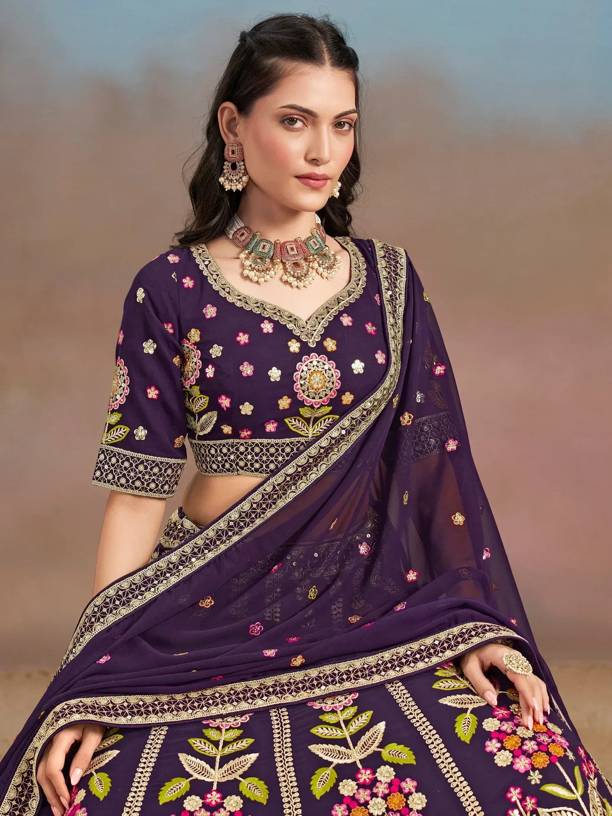 Purple embroidered lehenga choli with floral motifs and gold detailing, perfect for Indian ethnic wear occasions