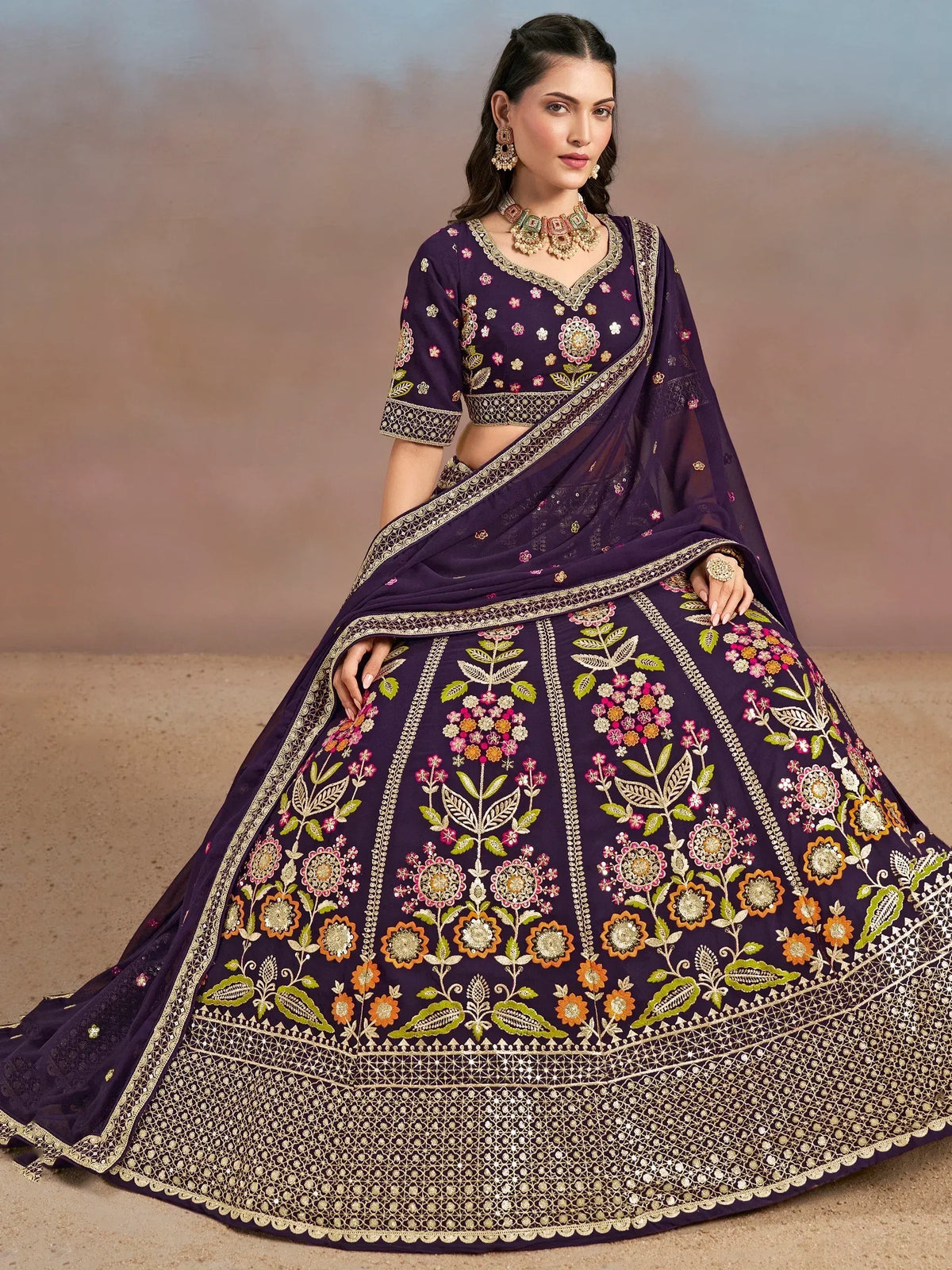 Purple floral embroidered lehenga choli with gold detailing, perfect for Indian weddings and festive occasions.