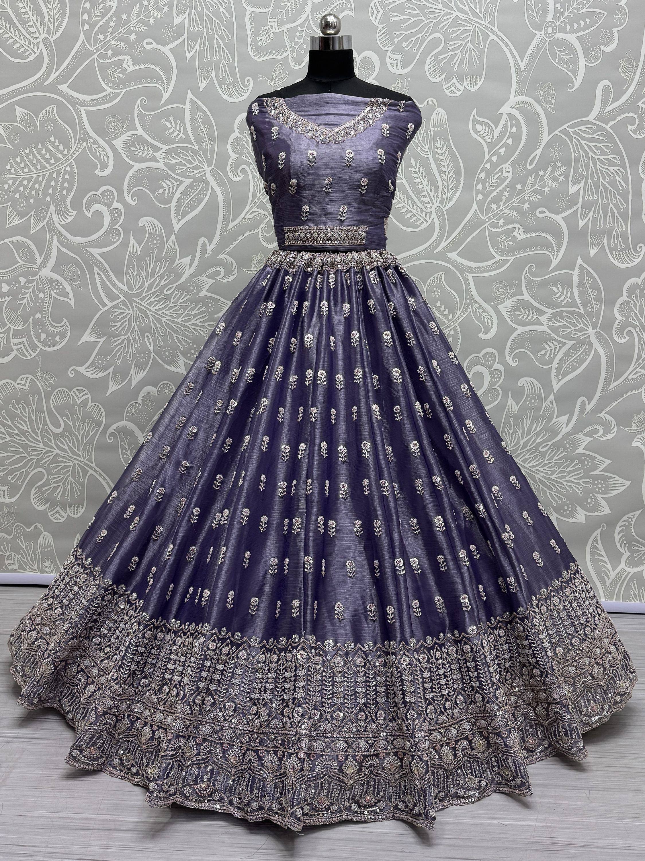 Elegant purple designer lehenga choli with intricate silver embroidery and floral motifs, perfect for Indian ethnic occasions.