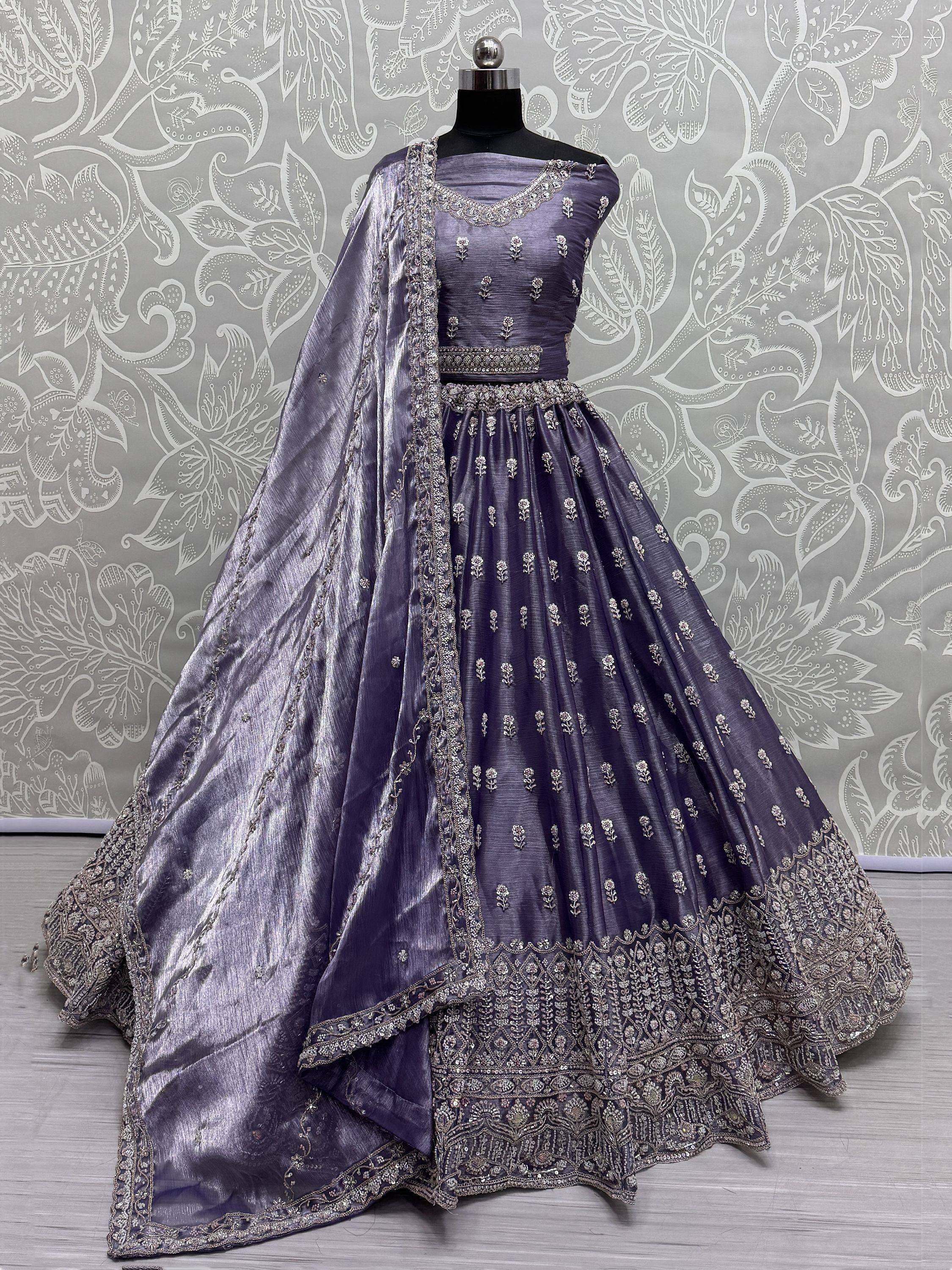 Elegant purple lehenga choli with silver embroidery and matching dupatta, displayed on mannequin
