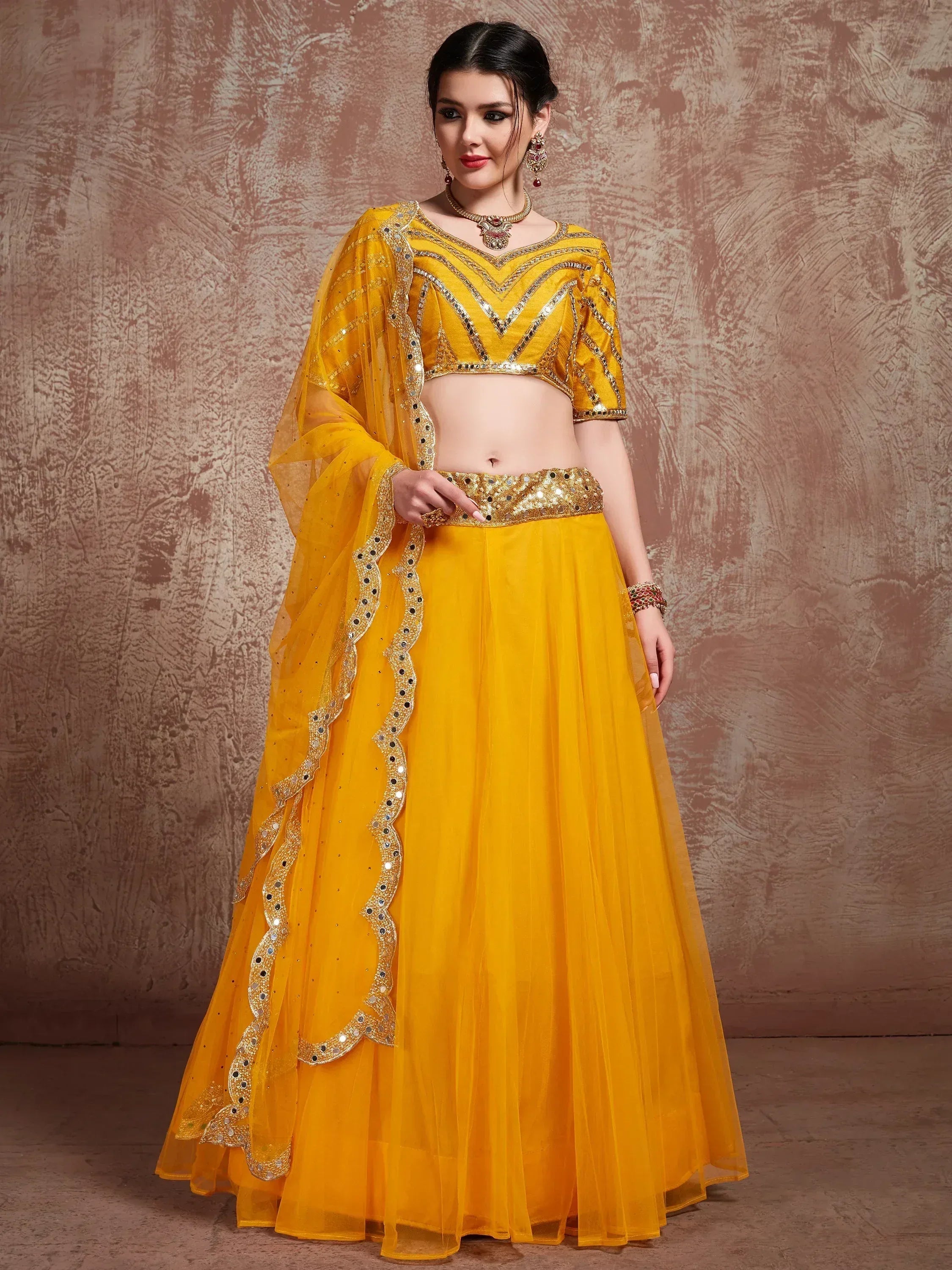 Yellow designer lehenga choli with mirror work and sheer dupatta, ethnic Indian wear