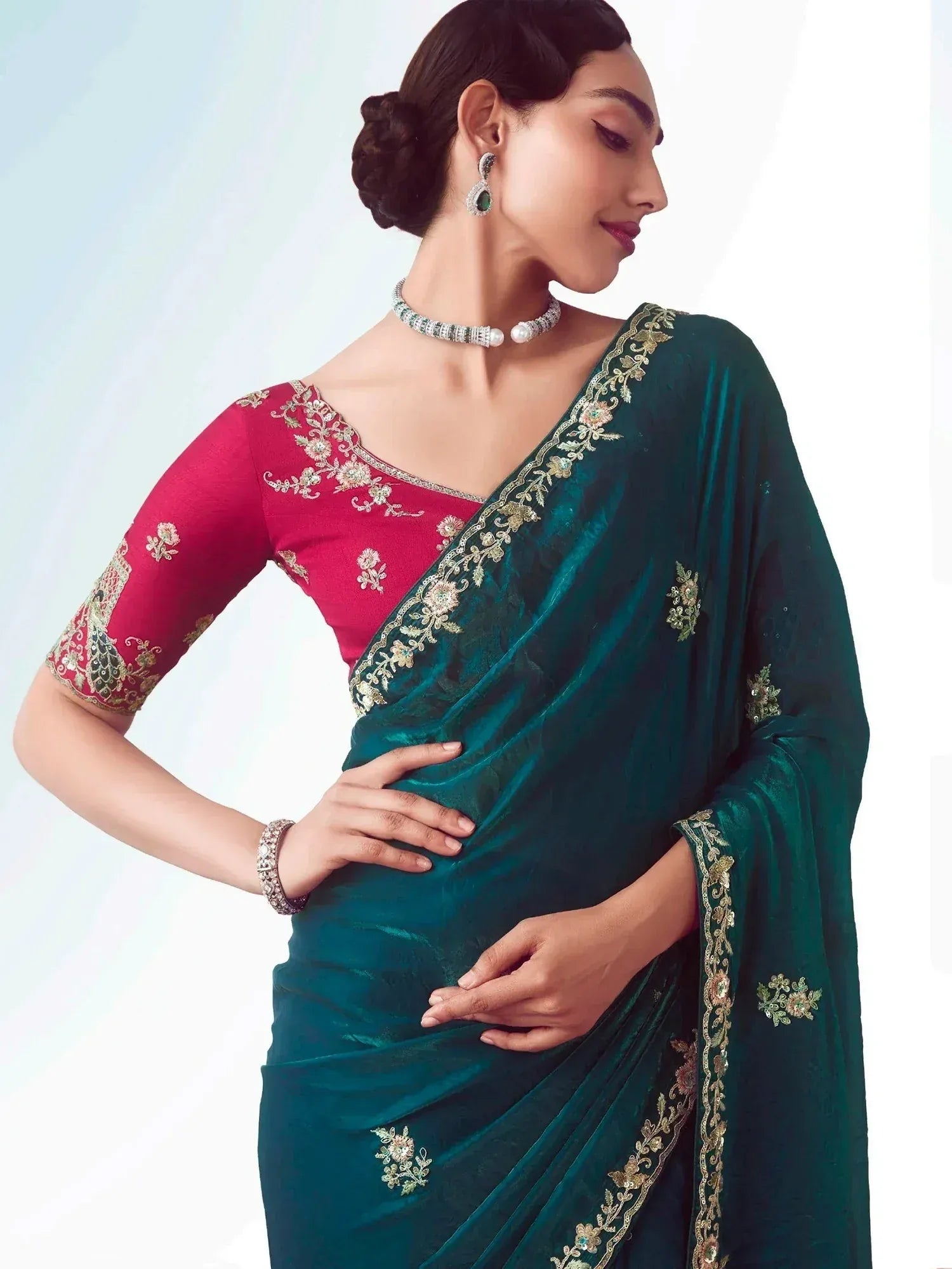 Emerald green velvet saree with gold floral embroidery and pink blouse, perfect for Indian ethnic occasions