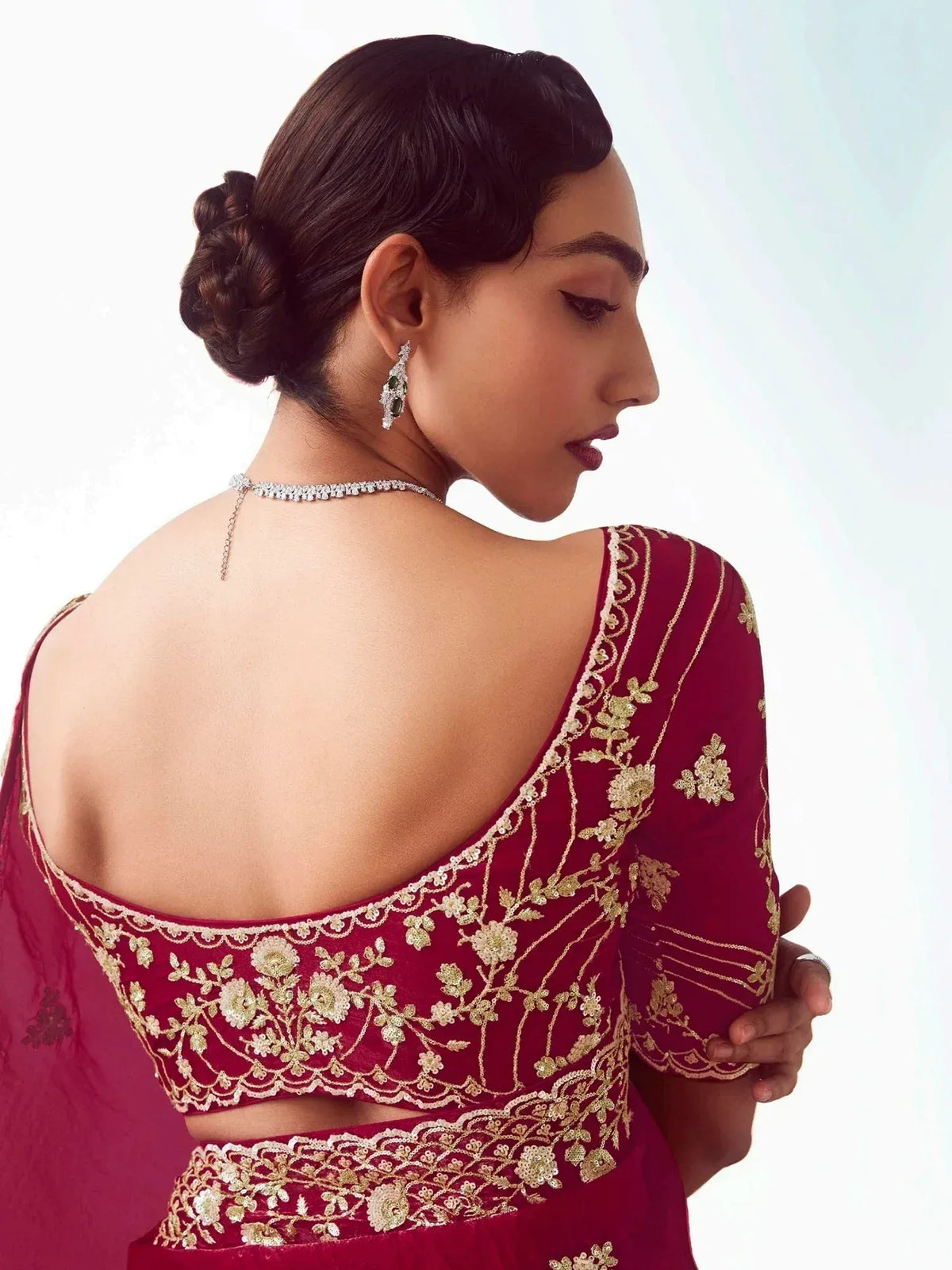 Maroon designer lehenga choli with gold floral embroidery and open back, perfect for weddings