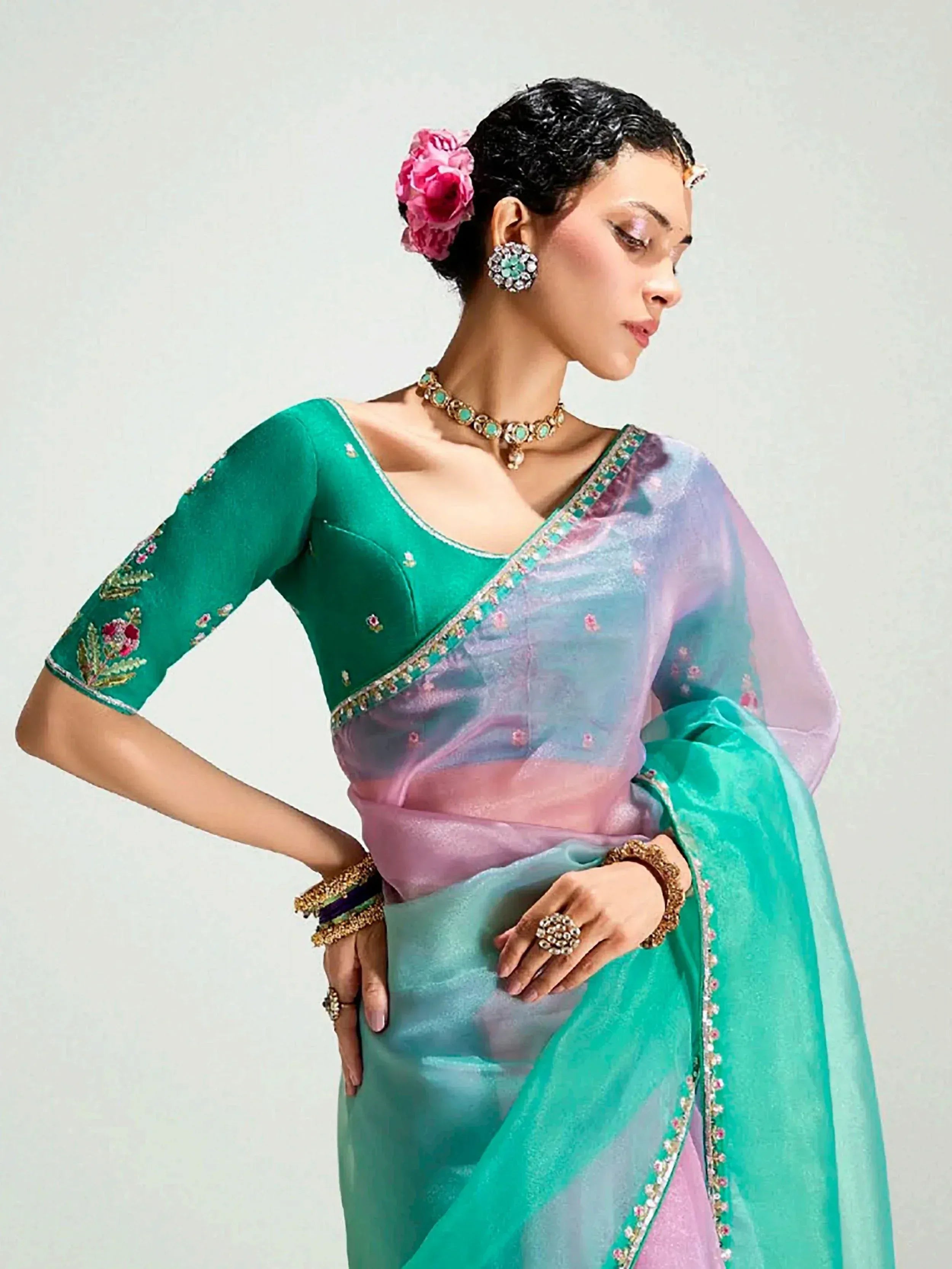 Woman in elegant green and pastel ombre saree with floral embroidery, perfect for Indian ethnic wear occasions.