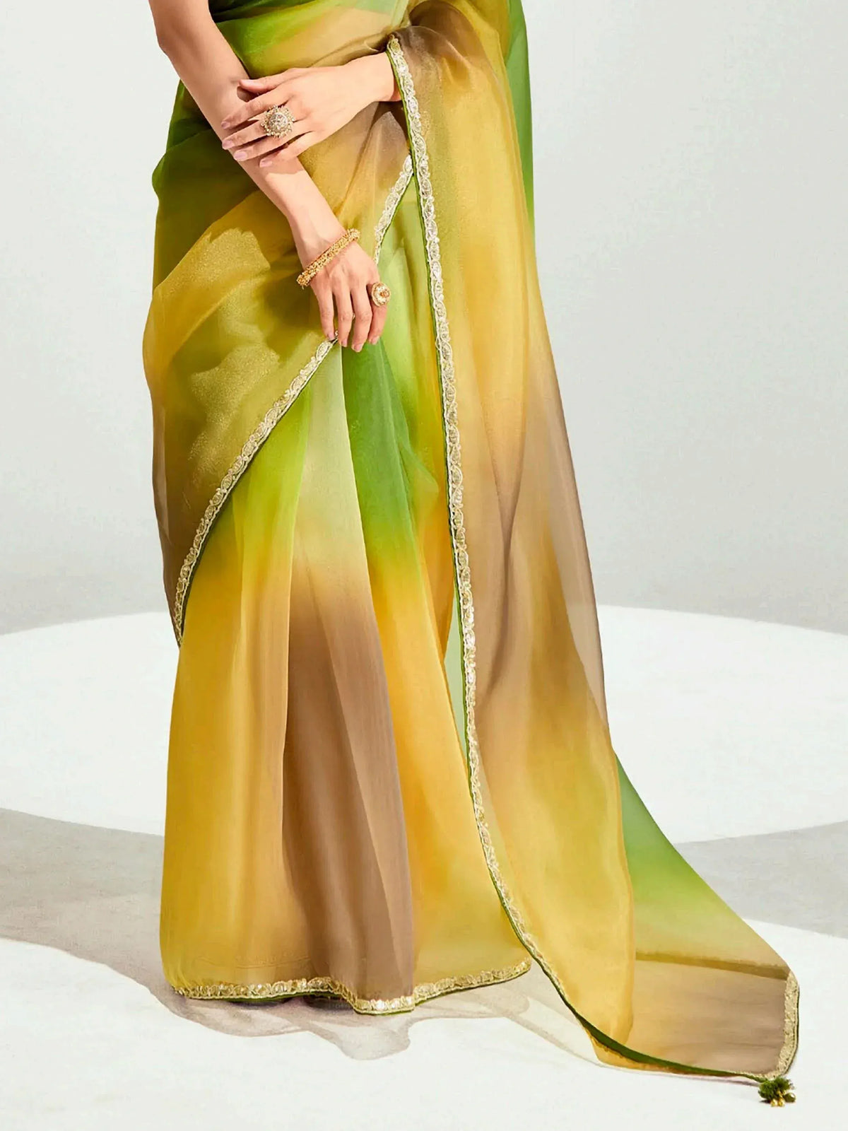 Green and yellow ombre saree with gold lace border, perfect for Indian ethnic wear occasions.