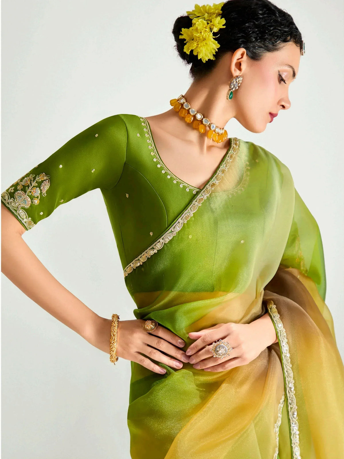 Green and yellow designer saree with gold embroidery, perfect for Indian ethnic wear occasions.