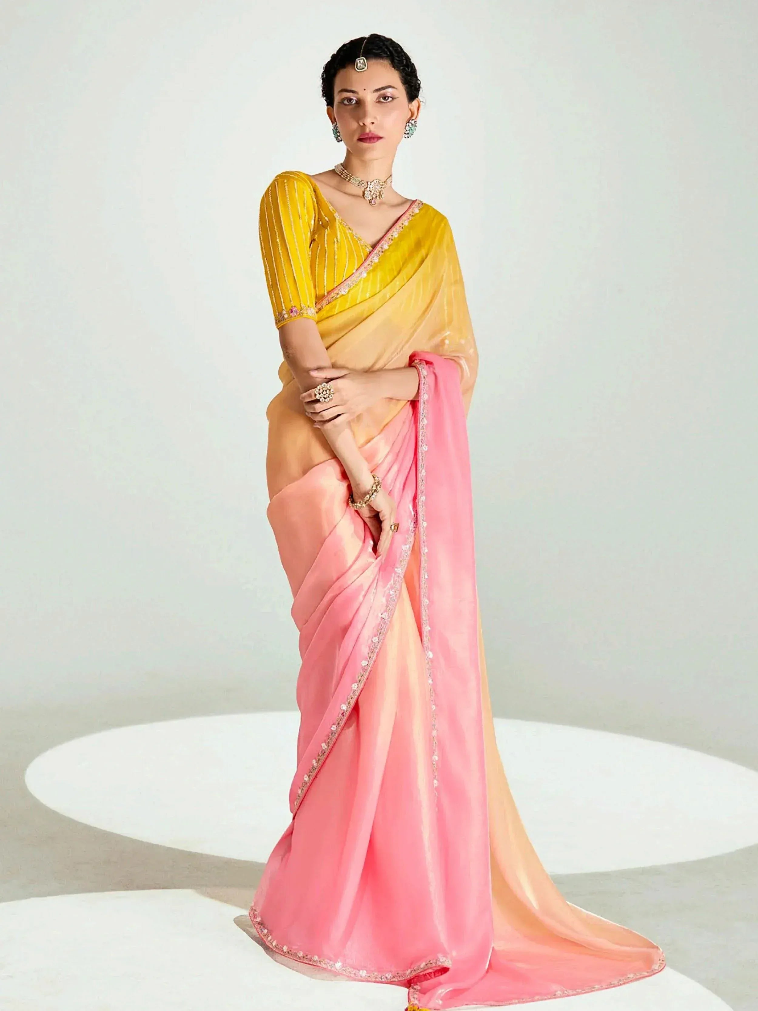 Elegant yellow and pink saree with intricate embroidery, perfect for Indian ethnic wear occasions.