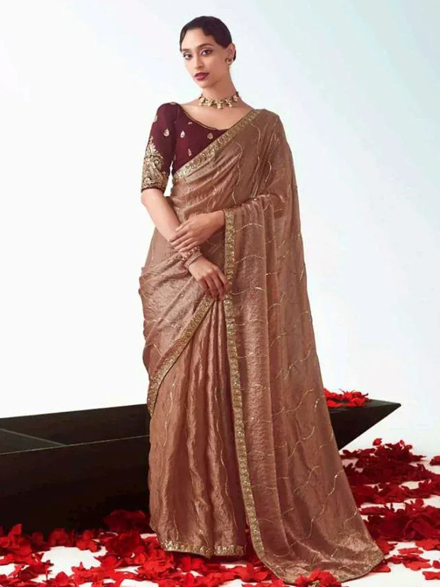 Elegant brown silk saree with gold embroidery, paired with maroon blouse, perfect for Indian ethnic occasions