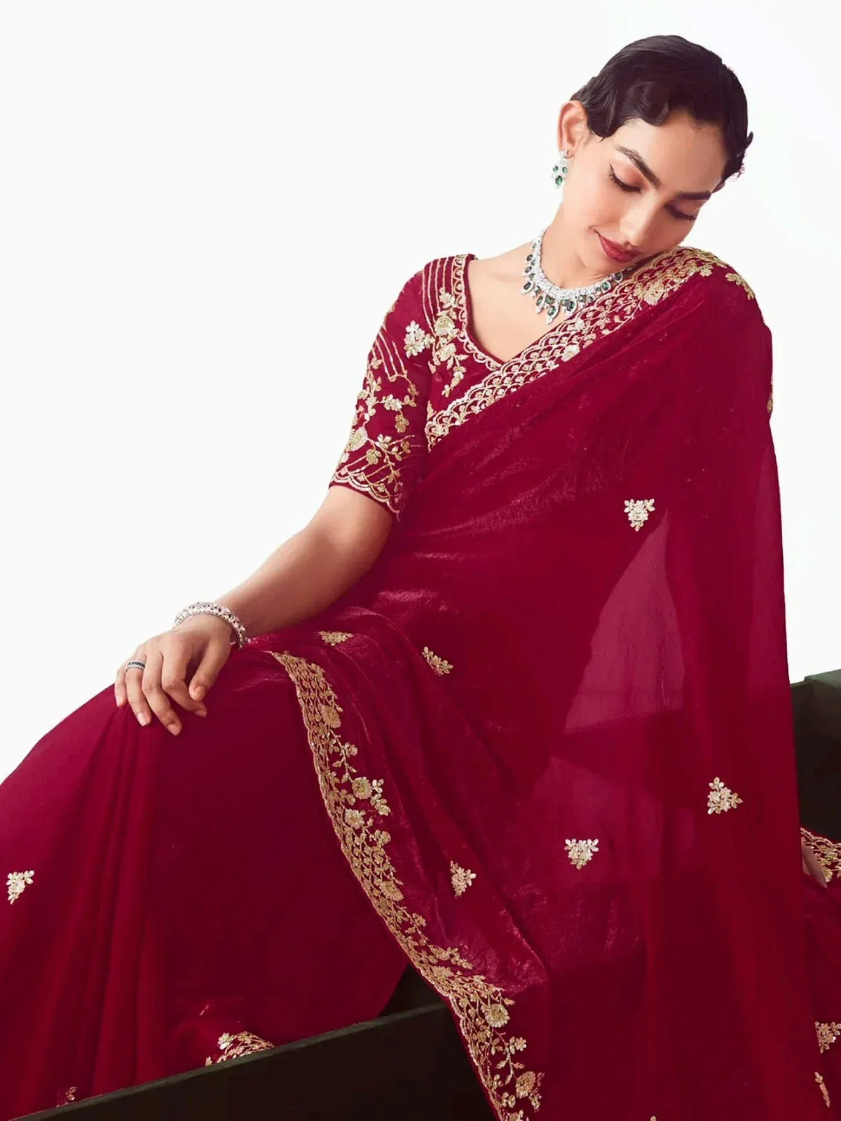 Elegant maroon velvet saree with gold embroidery, perfect for Indian ethnic wear and festive occasions.